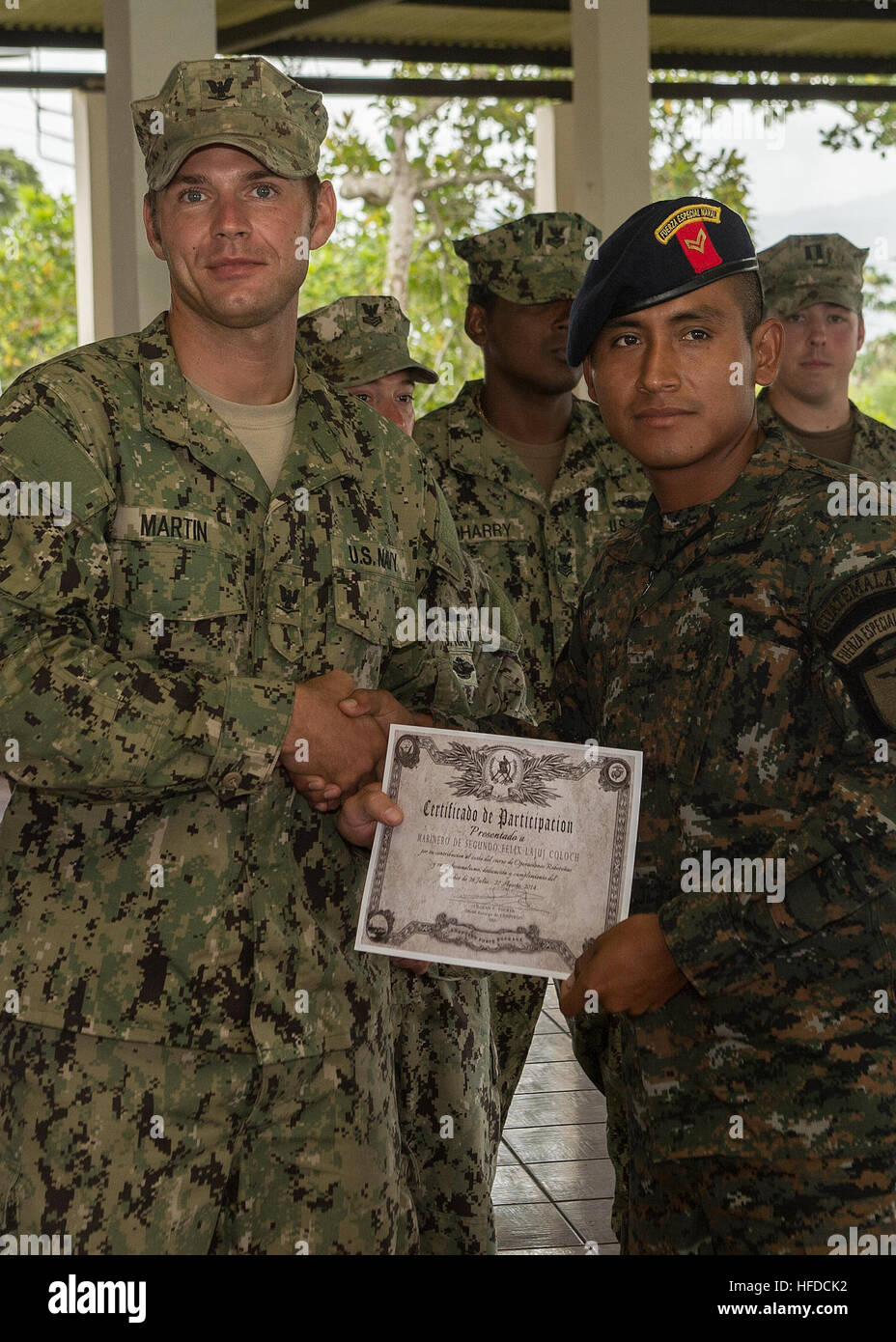 U.S. Navy Boatswain's Mate 3rd Class Zach Martin, left, attached to