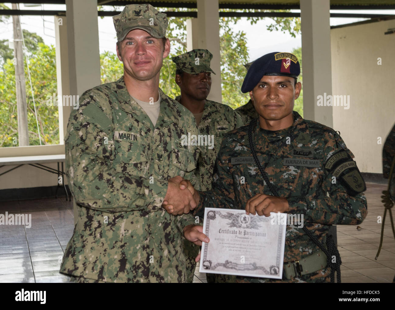 U.S. Navy Boatswain's Mate 3rd Class Zach Martin, left, attached to