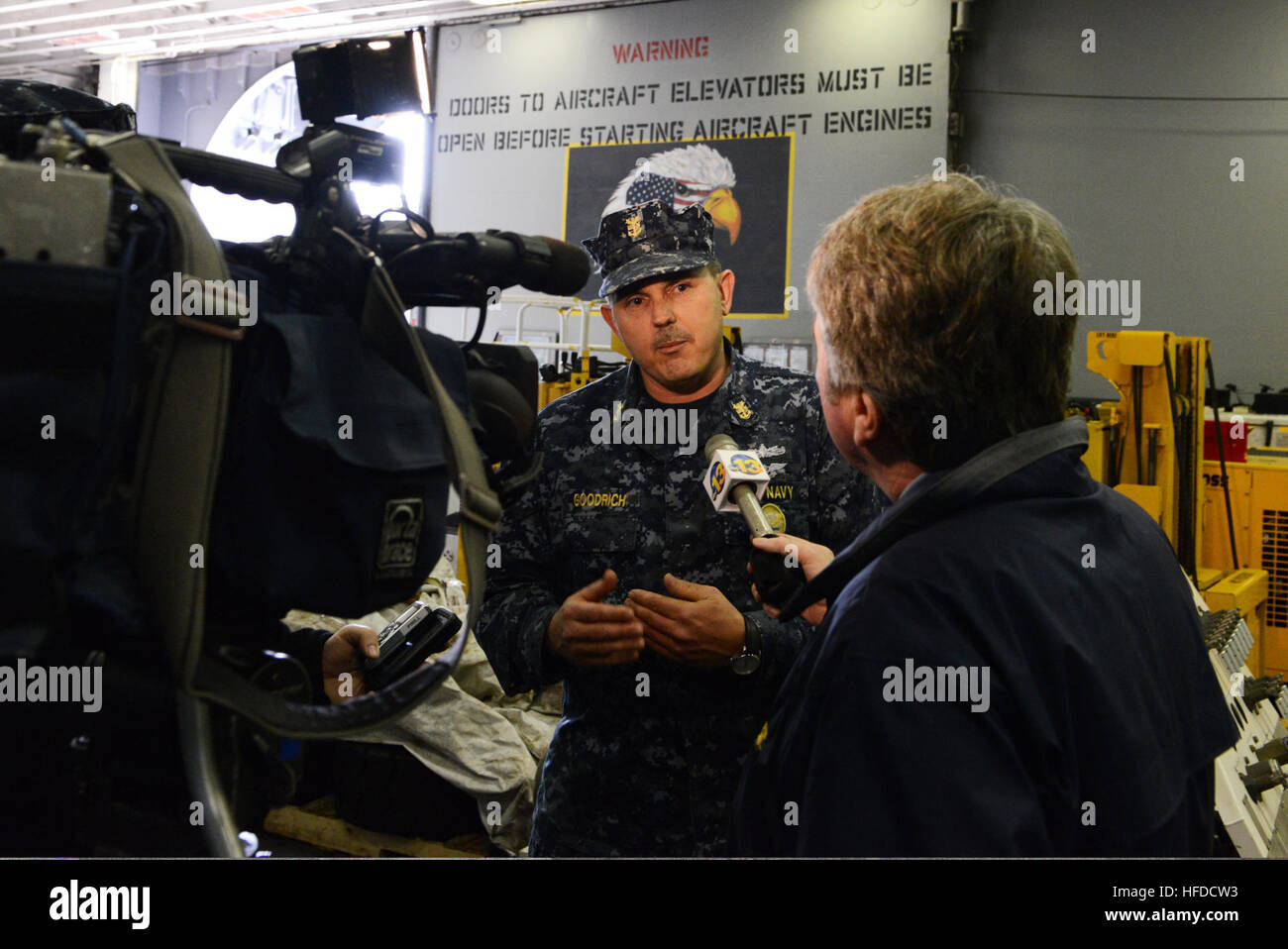 U.S. Navy Command Master Chief Kevin Goodrich, center, speaks to a