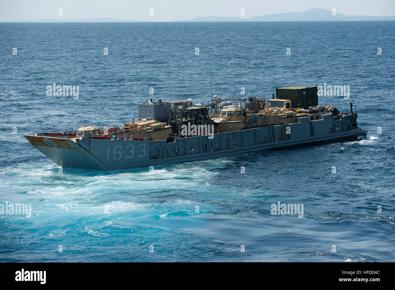 A landing craft utility departs the well deck of the forward-deployed ...
