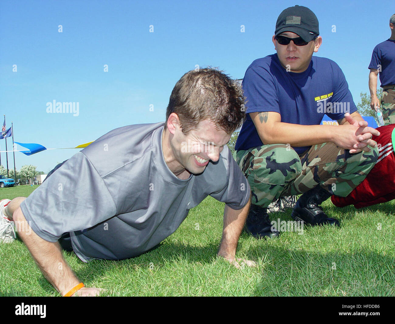 U.S. Navy Petty Officer 1st Class Chris Queen counts pushups for Chris