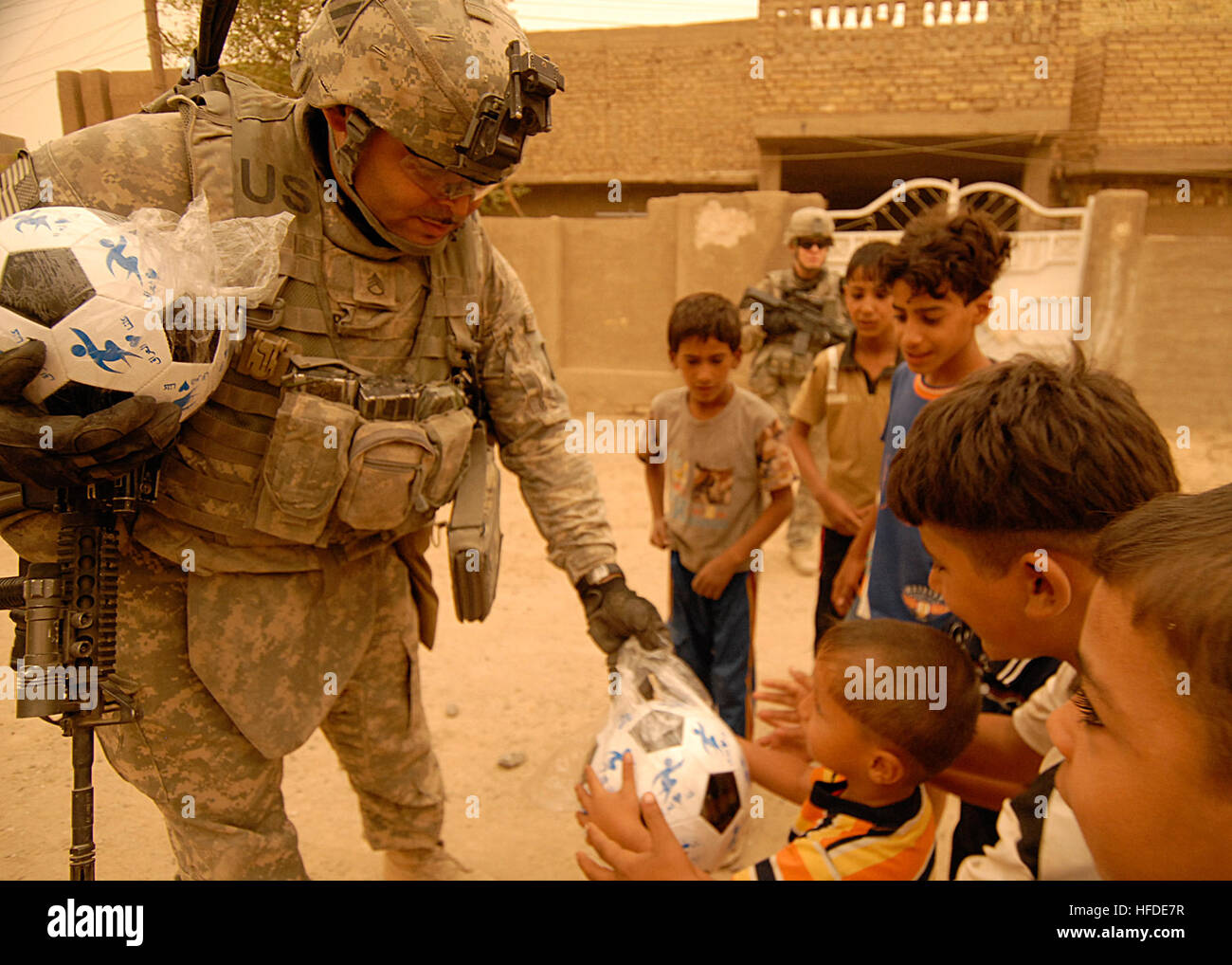 U.S. Army soldiers of 64th Armored Cavalry Regiment distribute soccer ...