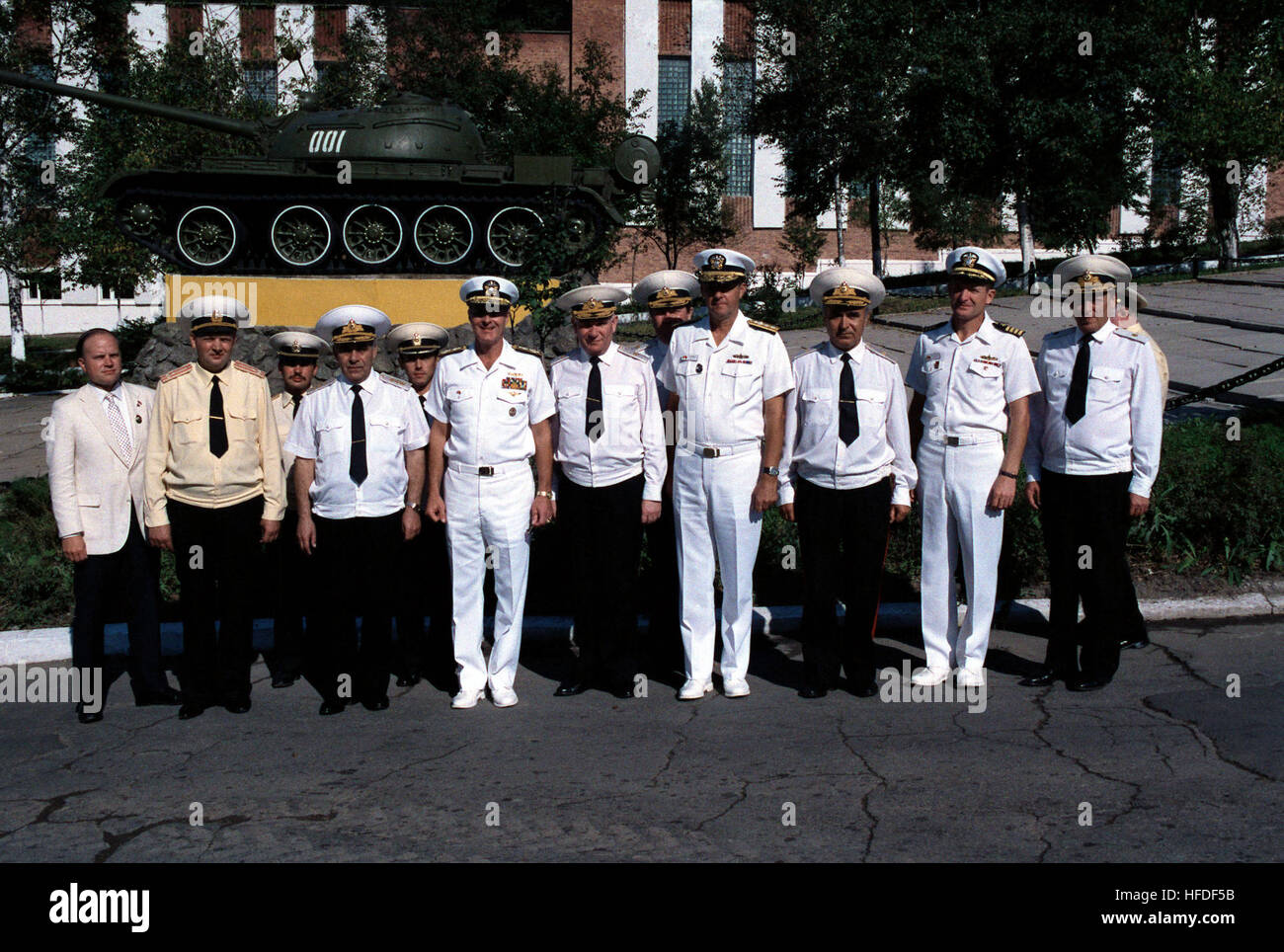 Admiral Gennadi Khvatov, front row, third from left, Commander, Soviet Pacific Fleet,  Admiral Charles R. Larson, front row, fourth from left, Commander in Chief, US Pacific Fleet, and other US and Soviet officers Soviet officers gather in front of a T-54 tank at a Soviet navy service school during a visit to the city by two US Navy ships.  The guided missile cruiser USS PRINCETON (CG-59) and the guided missile frigate USS REUBEN JAMES (FFG 57) are in Vladivostok for four days as part of a goodwill exchange program. US and Soviet navy officers in front of a T-55 tank at the Soviet navy service Stock Photo