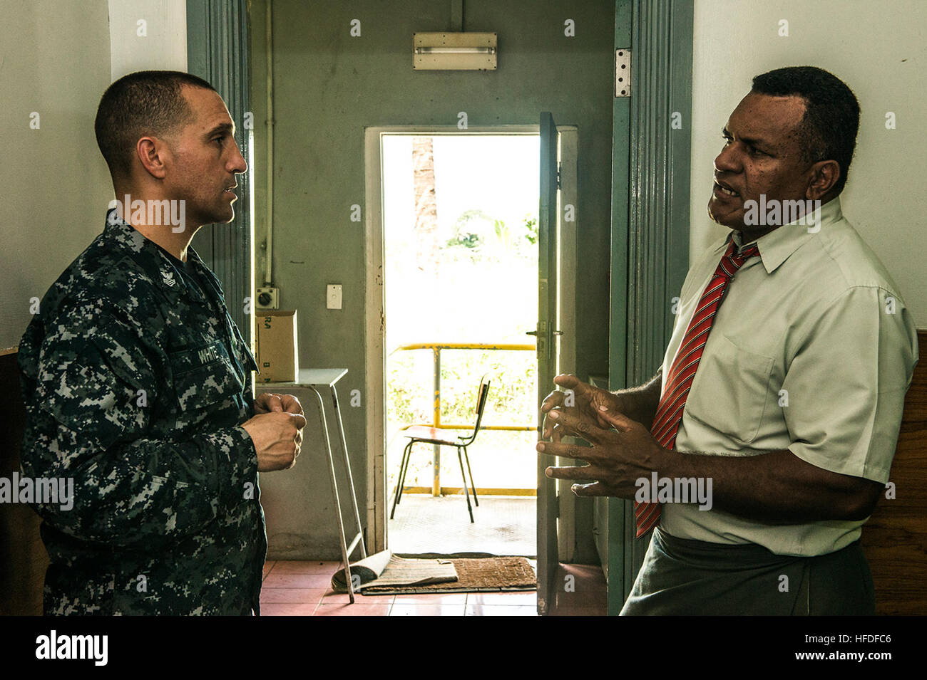 SUVA, Fiji (June 8, 2015) Hospital Corpsman 1st Class Nathan White discusses how to maintain medical equipment with a Republic of Fiji military forces biological technician during Pacific Partnership 2015. The hospital ship USNS Mercy (T-AH 19) is currently in Suva, Fiji, for its first mission port of PP15. Pacific Partnership is in its 10th iteration and is the largest annual multilateral humanitarian assistance and disaster relief preparedness mission conducted in the Indo-Asia-Pacific region. While training for crisis conditions, Pacific Partnership missions to date have provided real world Stock Photo