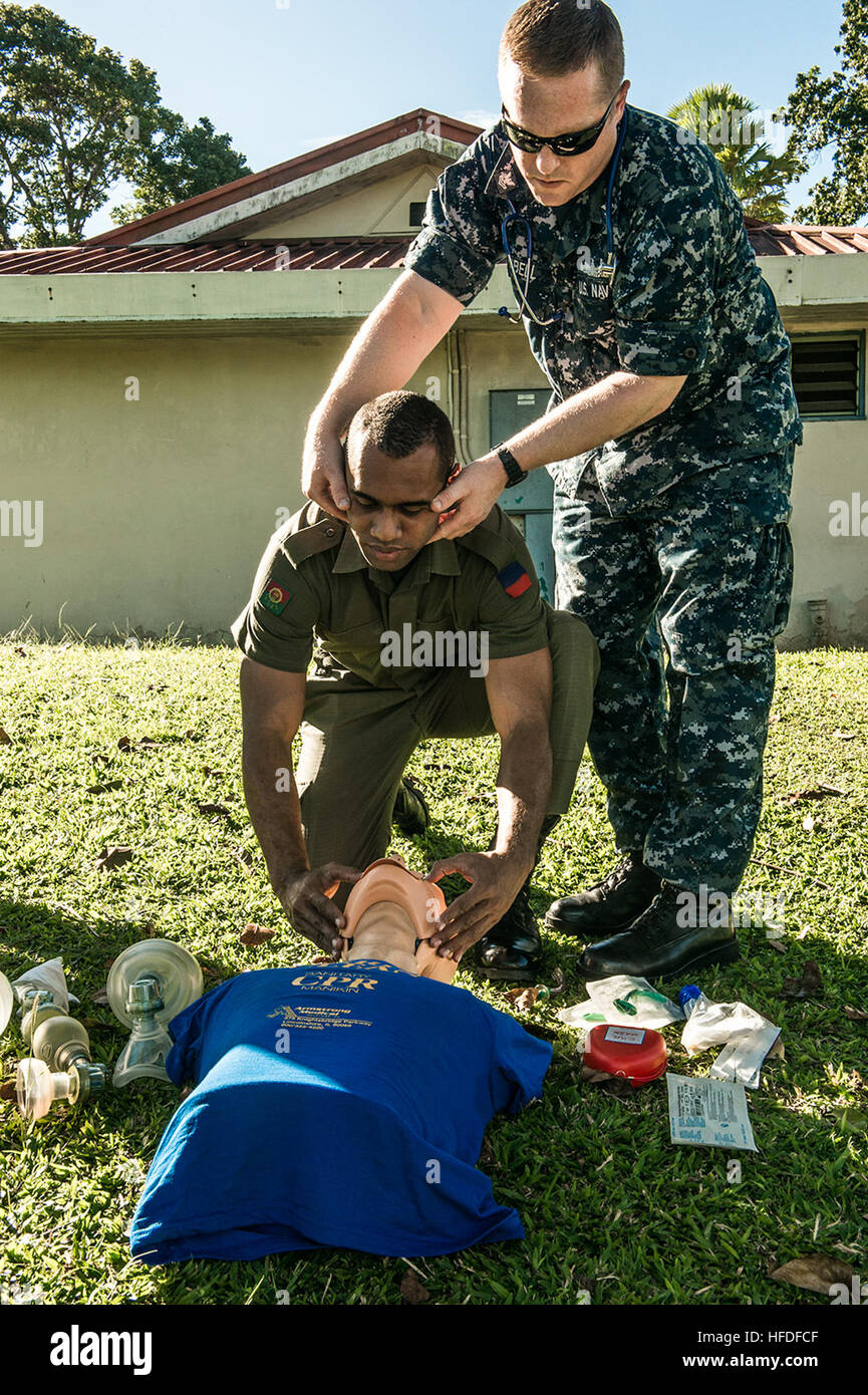 SUVA, Fiji (June 08, 2015) - Hospital Corpsman 2nd Class Ryan Cambell, assigned to the hospital ship USNS Mercy (T-AH 19), demonstrates to a Republic of Fiji military forces combat medic how to open a patients airway during Pacific Partnership 2015. Mercy is currently in Suva, Fiji, for its first mission port of PP15. Pacific Partnership is in its 10th iteration and is the largest annual multilateral humanitarian assistance and disaster relief preparedness mission conducted in the Indo-Asia-Pacific region. While training for crisis conditions, Pacific Partnership missions to date have provided Stock Photo