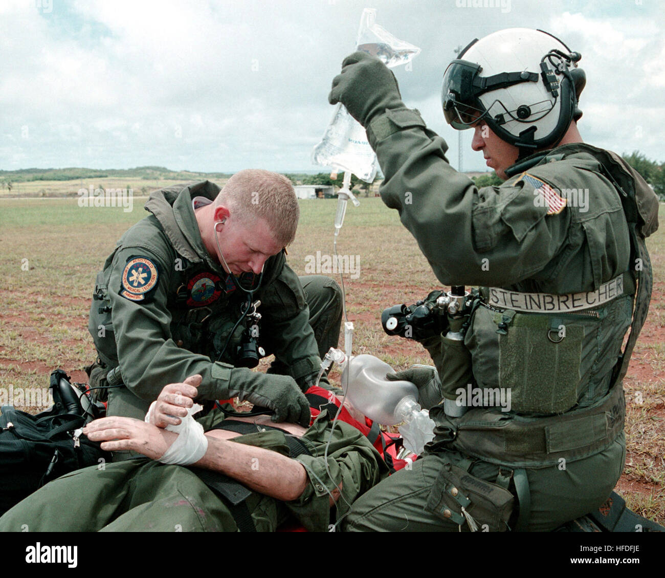 010531-N-3889M-004 Talofofo, Guam (May 31, 2001) -- Hospital Corpsman 3rd Class Raymond Munn from Cheyenne, WY, assigned to the 'Providers' of Helicopter Combat Support Squadron Five (HC-5), listens for correct tube placement on an intubated trauma victim during a search and rescue (SAR) exercise.  Aviation Machinist's Mate 3rd Class Todd Steinbrecher (right) from Kansas City, KS, assists in the simulated rescue. U.S. Navy photo by Photographer's Mate 2nd Class Marjorie McNamee.  (RELEASED) US Navy 010531-N-3889M-004 Navy Corpsman Field Training Exercise Stock Photo
