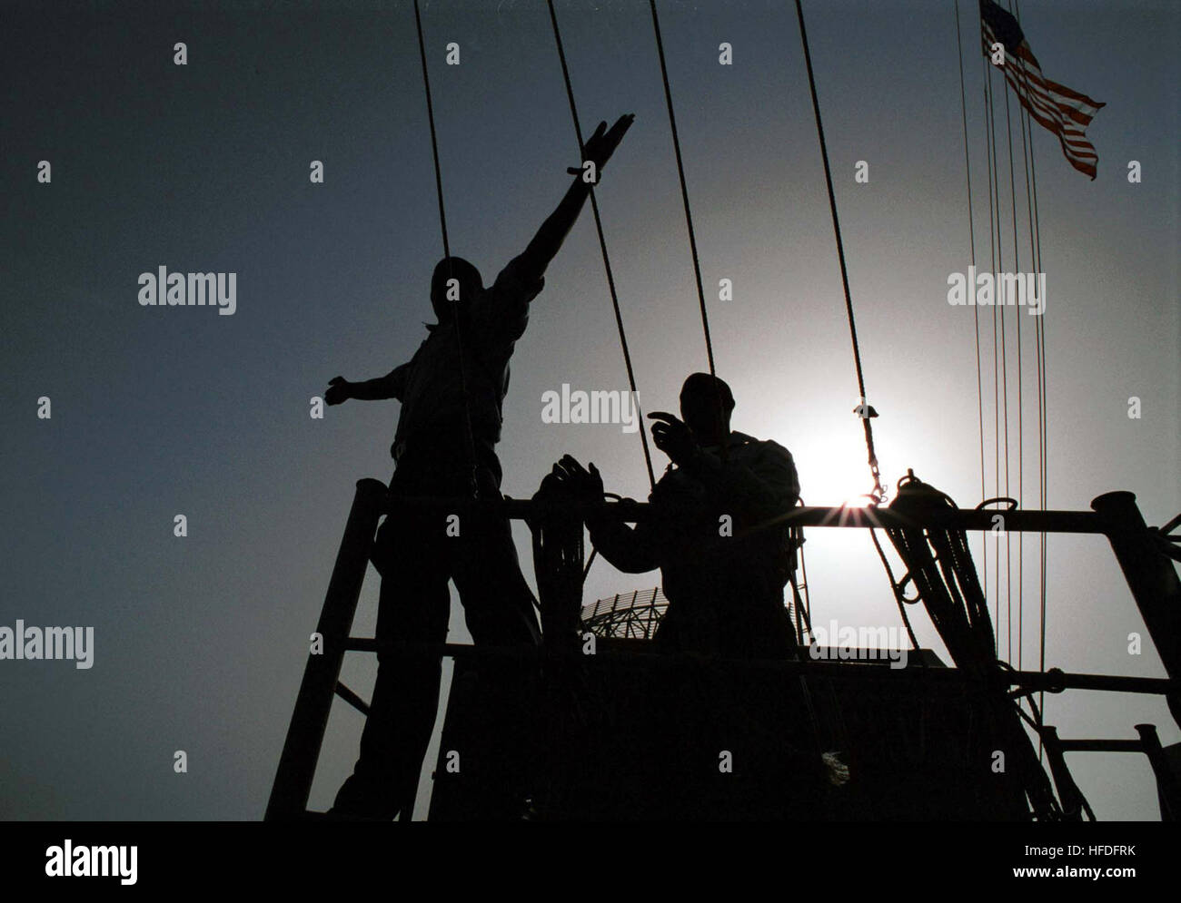 0110112-N-8386S-005 Aboard USS Carl Vinson (Oct. 12, 2001) Ð U.S. Navy Signalmen on board the aircraft carrier USS Carl Vinson (CVN 70) pass phonetic signals to the fast combat support ship USS Sacramento (AOE 1) during a vertical replenishment and refueling at sea evolution. USS Carl Vinson and its carrier airwing are conducting flight operations against terrorist training camps and Taliban military installations in Afghanistan. The carefully targeted actions are designed to disrupt the use of Afghanistan as a base for terrorist operations and to attack the military capability of the Taliban  Stock Photo