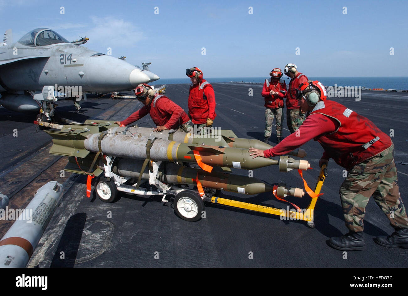 020303-N-4768W-026   At sea aboard USS John C. Stennis (CVN 74), Mar. 3, 2002 - U.S. Marine ordnance handlers load a 500-pound GBU-12 MK 83 laser guided bomb onto an F/A-18 'Hornet' strike fighter assigned to the 'Black Knights' of Marine Fighter Attack Squadron Three One Four (VMFA-314).  John C. Stennis and Carrier Air Wing Nine (CVW-9) are conducting combat missions over Afghanistan in support of Operation Enduring Freedom.  U.S. Navy photo by Photographer's Mate 3rd Class Joshua Word. (RELEASED) US Navy 020303-N-4768W-026 Loading bombs on aircraft at sea Stock Photo
