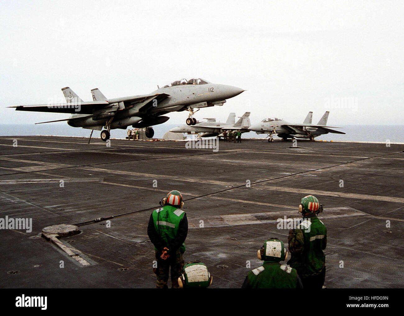 020312-N-7265D-005 At sea aboard USS Theodore Roosevelt (CVN 71) Mar. 12, 2002 -- An F-14 Tomcat jet fighter assigned to the 'Diamondbacks' of Fighter Squadron One Zero Two (VF-102) descends to make an arresting gear landing on the flight deck.  The aircraft carrier is operating in the Mediterranean Sea after conducting combat missions in support of Operation Enduring Freedom.  U.S. Navy photo by Photographer's Mate 3rd Class Sabrina A. Day.  (RELEASED) US Navy 020312-N-7265D-005 F-14 Stock Photo