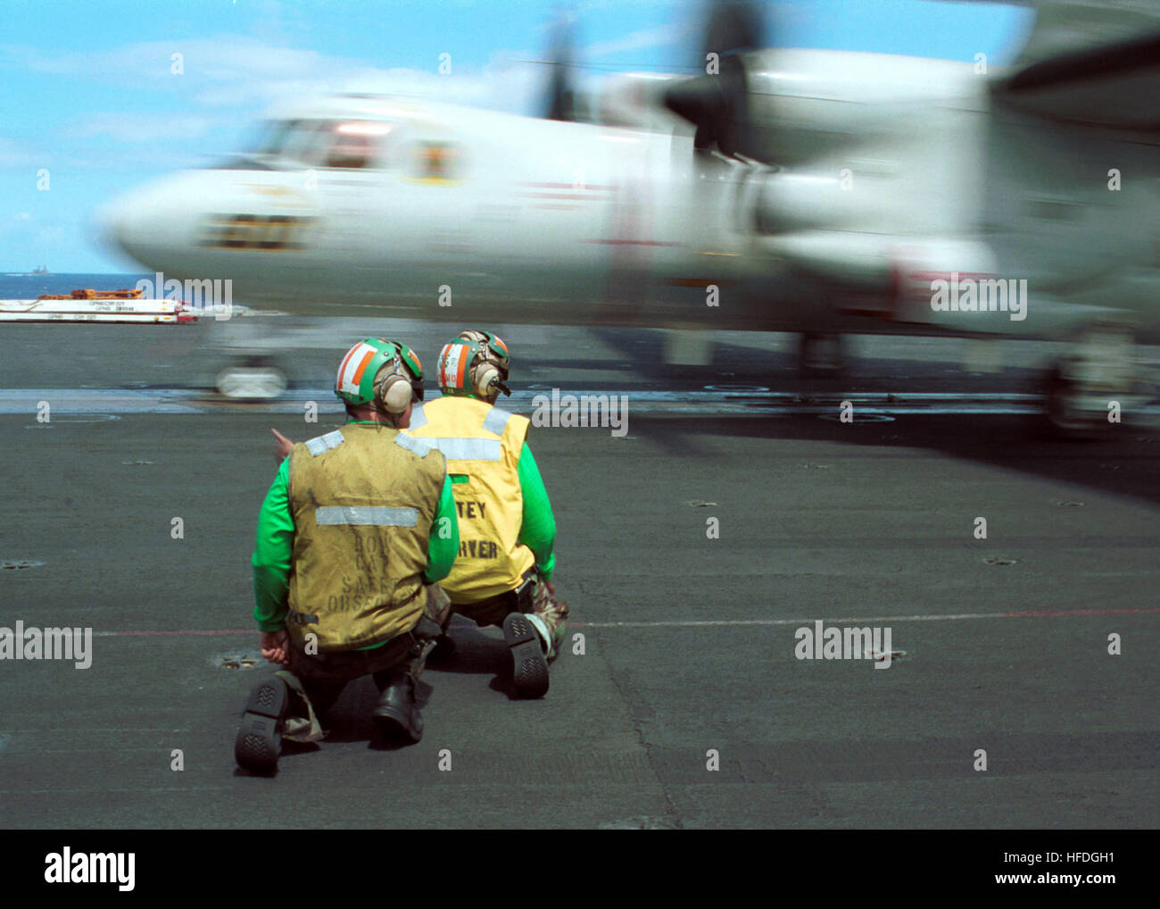 020410-N-3986D-002 At sea aboard USS George Washington (CVN 73) Apr. 10, 2002 -- Aviation Boatswain's Mate 3rd Class Paul Lee from Waycross, GA, and Aviation Boatswain's Mate Airman Weston Hull from New Orleans, LA, ensure the safe launch of an E-2C ÒHawkeyeÓ assigned to the ÒTigertailsÓ of Carrier Airborne Early Warning Squadron One Two Five  (VAW-125).  The Washington is homeported in Norfolk, VA, and is conducting scheduled integrated training operations in the Atlantic Ocean.  U.S. Navy photo by Photographer's Mate Airman Jessica Davis.  (RELEASED) US Navy 020410-N-3986D-002 USS Washington Stock Photo