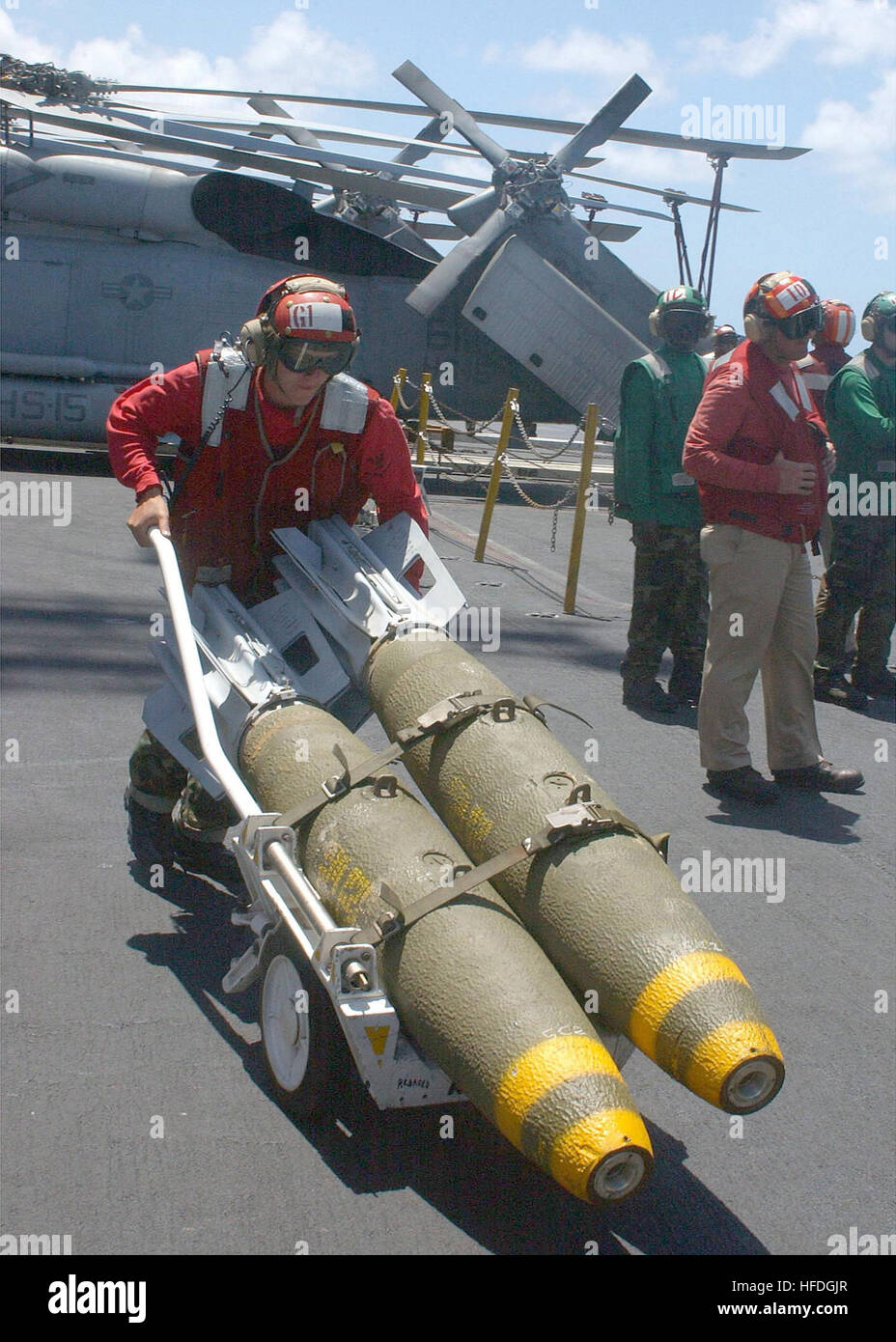 020417-N-4748O-003 At sea aboard USS George Washington (CVN 73) Apr. 17, 2002 -- Aviation Ordnanceman 3rd Class David Morris, of Montgomery, Al, transports 500 pound Mk-82 bombs across the shipÕs flight deck.  Washington is homeported in Norfolk, Va, and is conducting scheduled integrated training exercises in the Atlantic Ocean.  U.S. Navy photo by Photographer's Mate Airman Geanine Ortez.  (RELEASED) US Navy 020417-N-4748O-003 Aviation Ordnanceman David Morris Stock Photo
