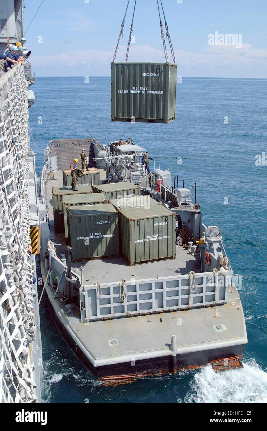 020721-N-8590G-010 Aboard USS Fort McHenry (LSD 43) -- Equipment from the Naval Construction Task Group (NCTG) is transported aboard the amphibious dock landing ship USS Fort McHenry using one of the ship’s cranes.  Fort McHenry is off the coast of Basilan Island in the Southern Philippines, on-loading more than 300 U.S. Navy Seabees and Marine engineers. These Sailors and Marines from U.S. bases in Okinawa, Japan, are working on infrastructure improvements on the island. Military forces are involved in projects such as airfields, roads, and bridges, which also benefit the local area residents Stock Photo