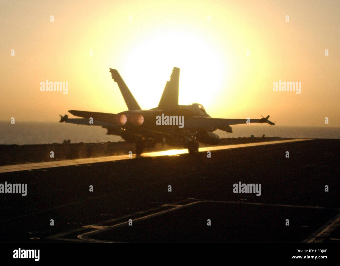 020904-N-2147L-005 At sea aboard USS George Washington (CVN 73) Sept. 4, 2002 --  An F/A-18 'Hornet' from Carrier Airwing Seventeen (CVW 17) lands on the flight deck during evening flight operations.  The Washington Battlegroup is on a regularly scheduled deployment in support of Operation Southern Watch.  U.S. Navy photo by Photographer's Mate 2nd Class Corey T. Lewis.  (RELEASED) US Navy 020904-N-2147L-005 An F-A-18 Hornet returns aboard the USS George Washington (CVN 73) Stock Photo