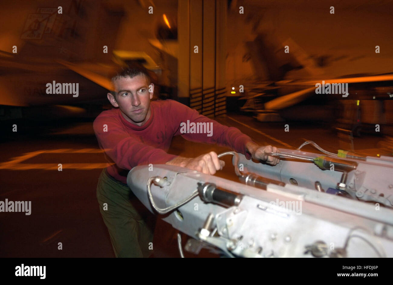 020918-N-9411J-003 At sea aboard USS Nimitz (CVN 68) Sep. 18, 2002 -- Aviation Ordnanceman 3rd Class Chris Blakeman from Gillette, Wyo., guides multiple ejector racks to the ship’s upper stage weapons elevator two before morning flight quarters. Nimitz is undergoing Tailored Ships Training Availability (TSTA) Two and Three off the California coast.  U.S. Navy photo by Photographer’s Mate 3rd Class Christopher Leroy Jordan.  (RELEASED) US Navy 020918-N-9411J-003 Guiding multiple ejector racks aboard USS Nimitz Stock Photo