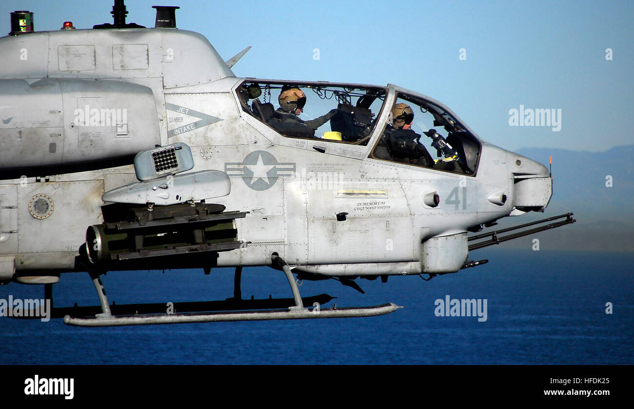 081107-N-4774B-138 PACIFIC OCEAN (Nov. 7, 2008) An AH-1 Cobra attack helicopter pilot and weapons controller assigned to Marine Medium Helicopter Squadron 163 (REIN) approach amphibious assault ship USS Boxer (LHD 4). Boxer is conducting a composite training unit exercise preparing for a regularly scheduled deployment early next year. (U.S. Navy Photo by Mass Communication Specialist 3rd Class Daniel Barker/Released) 081107-N-4774B-138 Stock Photo