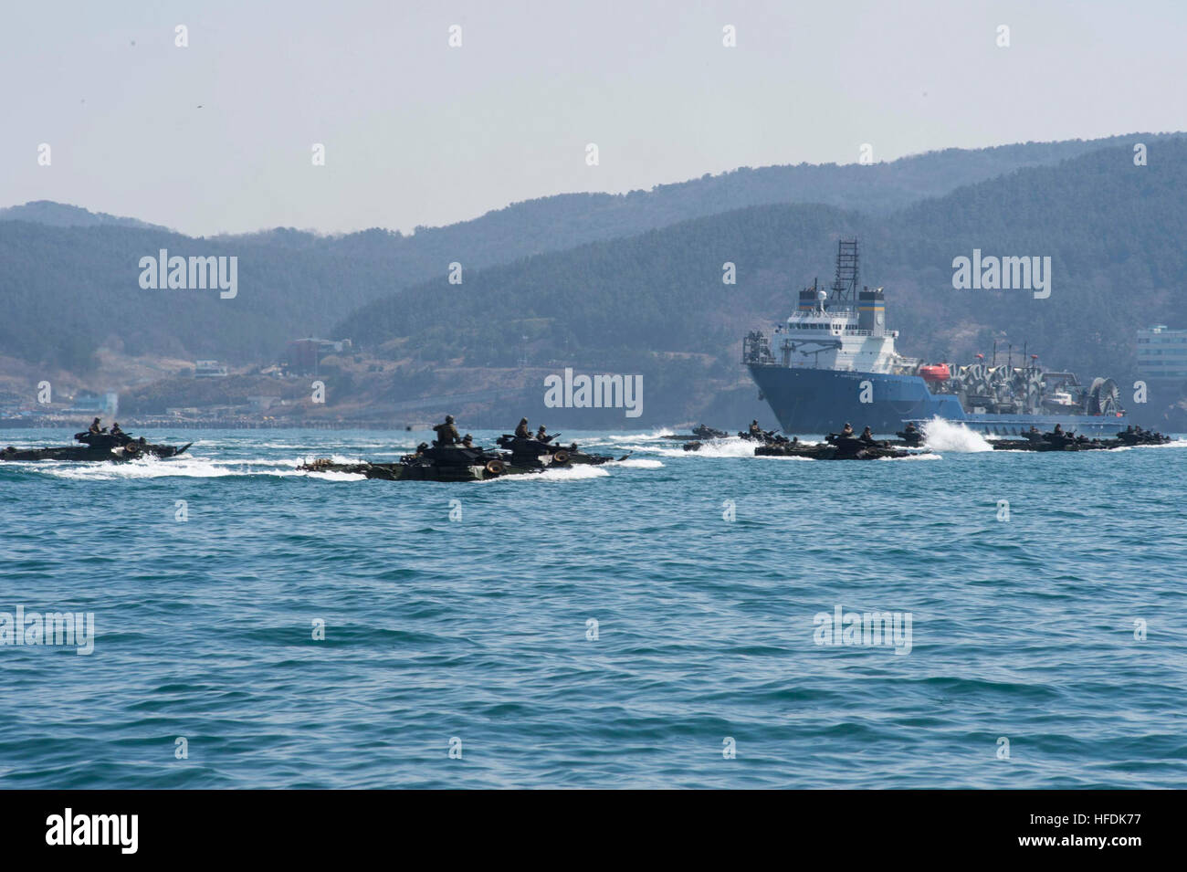 160312-N-RM689-100 EAST SEA (March 12, 2016)- Amphibious assault vehicles (AAV), attached to the 31st Marine Expeditionary Unit (MEU) aboard amphibious dock landing ship USS Ashland (LSD 48), drive towards the beach during the amphibious capabilities exercise of Ssang Yong 16 (SY 16). Ashland is assigned to the Bonhomme Richard Expeditionary Strike Group and is participating in SY 16, a biennial combined amphibious exercise conducted by forward-deployed U.S. forces with the Republic of Korea navy and Marine Corps, Australian army and Royal New Zealand army forces in order to strengthen our int Stock Photo