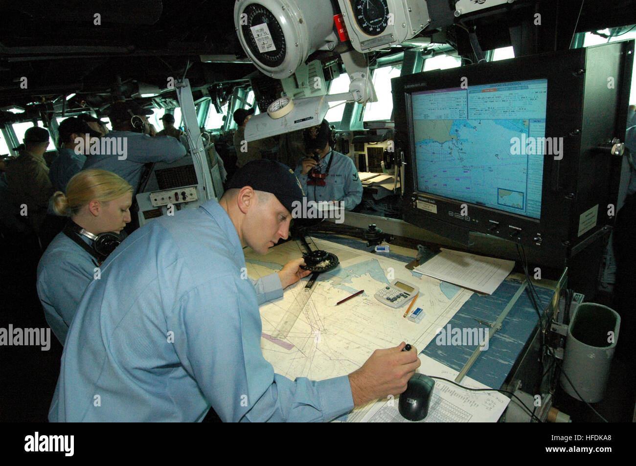 061012-N-1328S-001 Indian Ocean (Oct. 12, 2006) - Quartermasters assigned to USS Boxer (LHD 4) plot the shipÕs course as it pulls into Changi Naval Base, Singapore for a port visit. Boxer is the flagship of Boxer Expeditionary Strike Group operating from San Diego as the Navy's only forward-deployed amphibious task force. U.S. Navy photo by Mass Communication Specialist Seaman James Seward (RELEASED) Analog and digital Nautical chart Stock Photo