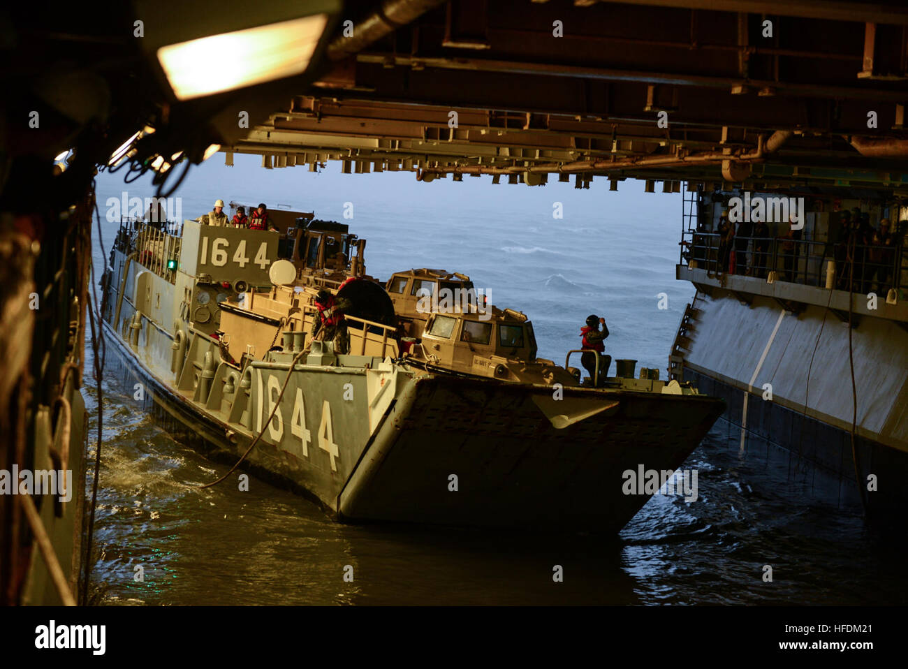 NORFOLK (Oct. 8, 2016) Landing Craft Utility (LCU) 1644, attached to Assault Craft Unit (ACU) 2, enters the well deck of the amphibious assault ship USS Iwo Jima (LHD 7). Iwo Jima and the 24th Marine Expeditionary Unit (24th MEU) are preparing to provide disaster relief and humanitarian aid to Haiti following Hurricane Matthew. (U.S. Navy photo by Seaman Daniel C. Coxwest/Released) 161008-N-AH771-177 Join the conversation: www.navy.mil/viewGallery.asp www.facebook.com/USNavy www.twitter.com/USNavy navylive.dodlive.mil pinterest.com plus.google.com An LCU enters the well deck of the amphibious  Stock Photo