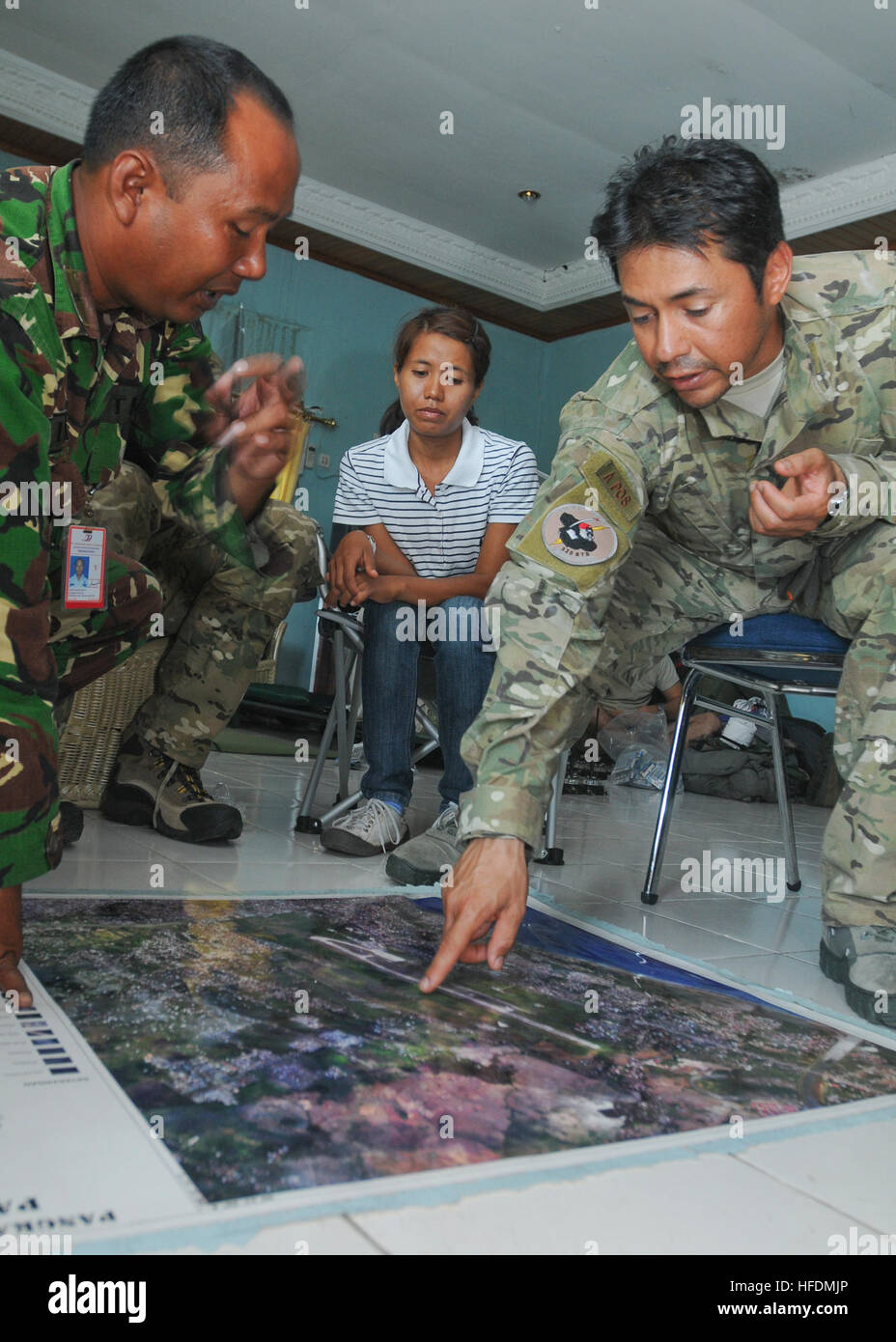 U.S. Air Force Staff Sgt. Christopher Lugo, right, assigned to the 353rd Special Operations Group, points out damaged aviation navigation aids during a meeting with Indonesian airmen at Ta Bing Air Field in Padang, Indonesia, Oct. 7, 2009. The service members are meeting to discuss the restoration of the aids to better facilitate flight operations in support of ongoing humanitarian relief efforts in Padang. The U.S. military is responding to a request for assistance by the Indonesian government after a 7.6 magnitude earthquake struck the country Sept. 30, 2009. (DoD photo by Mass Communication Stock Photo