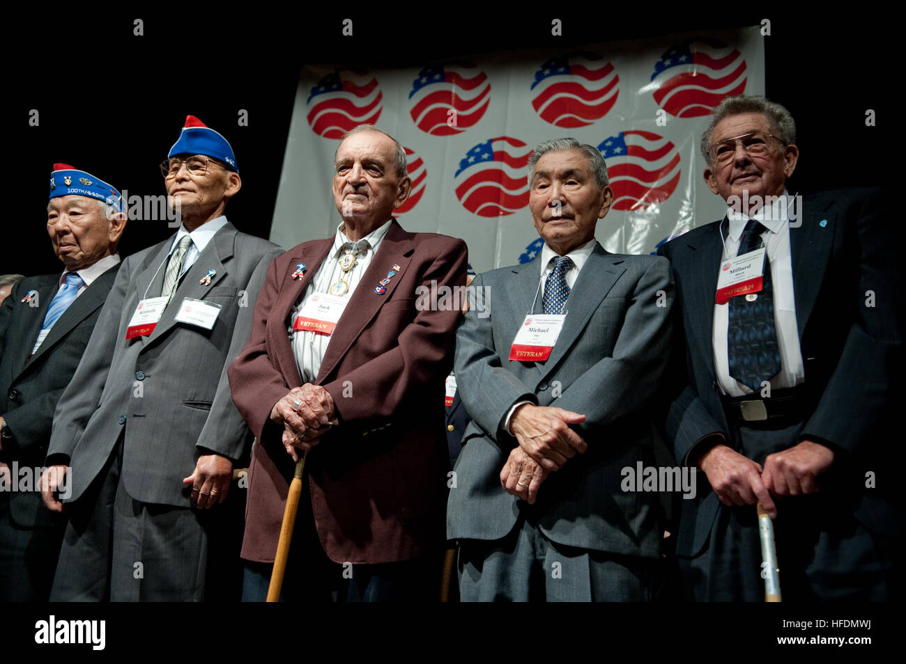 U.S. Army veterans from the 141st Infantry Regiment and the 442nd Regimental Combat Team stand during the 65th Anniversary Tribute dinner for the veterans of the Rescue of the Lost Battalion in Houston, Texas, Nov. 1, 2009. The dinner commemorates a battle in 1944, when the 141st was surrounded by Nazi forces in the Vosges Mountains of Northern France. After several failed attempts to reach the unit, the 442nd, a segregated unit comprised of mostly Japanese-Americans, fought for five days to break through Nazi lines and reach the battalion, rescuing 230 men. (DoD photo by Mass Communication Sp Stock Photo