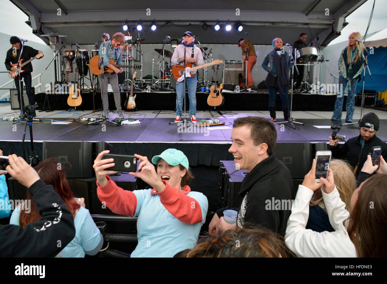 YOKOSUKA, Japan (October 30, 2016) – A person in the crowd takes a selfie with recording Artist Jimmy Buffett and the Coral Reefer Band during a Navy Entertainment Sponsored concert for Sailors and family members at Fleet Activities (FLEACT) Yokosuka.  FLEACT Yokosuka provides, maintains, and operates base facilities and services in support of 7th Fleet’s forward-deployed naval forces, 83 tenant commands, and 24,000 military and civilian personnel. (U.S. Navy photo by Petty Officer 1st Class Peter Burghart/Released)161030-N-XN177-044  Join the conversation: http://www.navy.mil/viewGallery.asp  Stock Photo