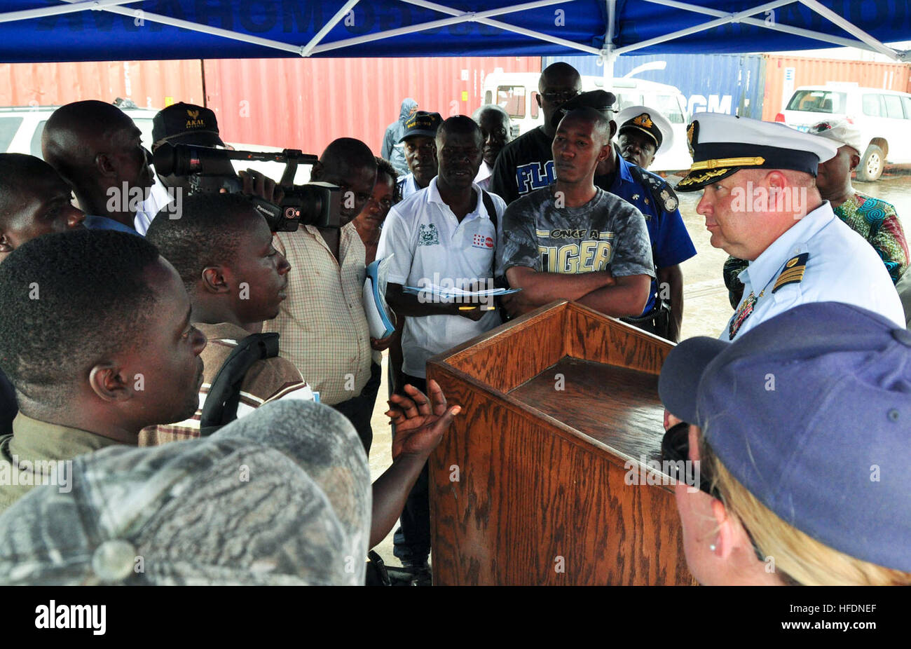 Cmdr. Robert T. Hendrickson, commanding officer of U.S. Coast Guard Cutter Mohawk (WMEC 913), speaks to local media during a press conference on the pier during a port visit to Freetown. Mohawk recently participated in the African Maritime Law Enforcement Partnership, a mission that focuses on enhancing cooperative partnerships with regional maritime services to achieve common international goals such as stability and security. Mohawk, homeported in Key West, Fla., is on a scheduled deployment in the U.S. 6th Fleet area of responsibility. (Photo by: Petty Officer 1st Class Daniel P. Lapierre)  Stock Photo