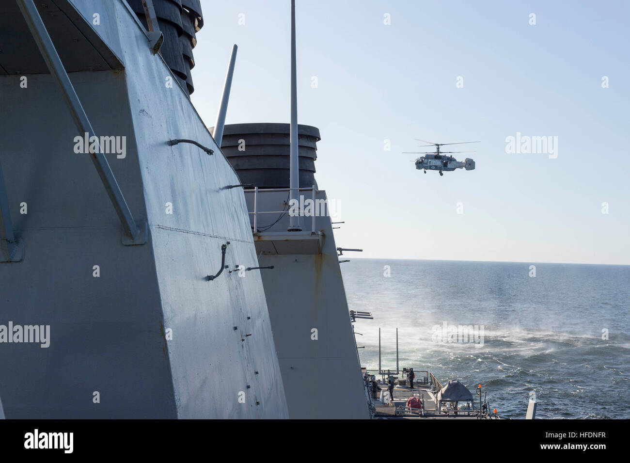 160412-N-00000-003 BALTIC SEA - A Russian Kamov KA-27 HELIX flies low-level passes near the Arleigh Burke-class guided missile destroyer USS Donald Cook (DDG 75) while the ship was operating in international waters Apr. 12, 2016. Donald Cook is forward deployed to Rota, Spain, and is conducting routine patrols in the U.S. 6th Fleet area of operations in support of U.S. national security interests in Europe.  (U.S. Navy photo/Released) A Russian Kamov KA-27 flies near the USS Donald Cook (DDG 75) Stock Photo