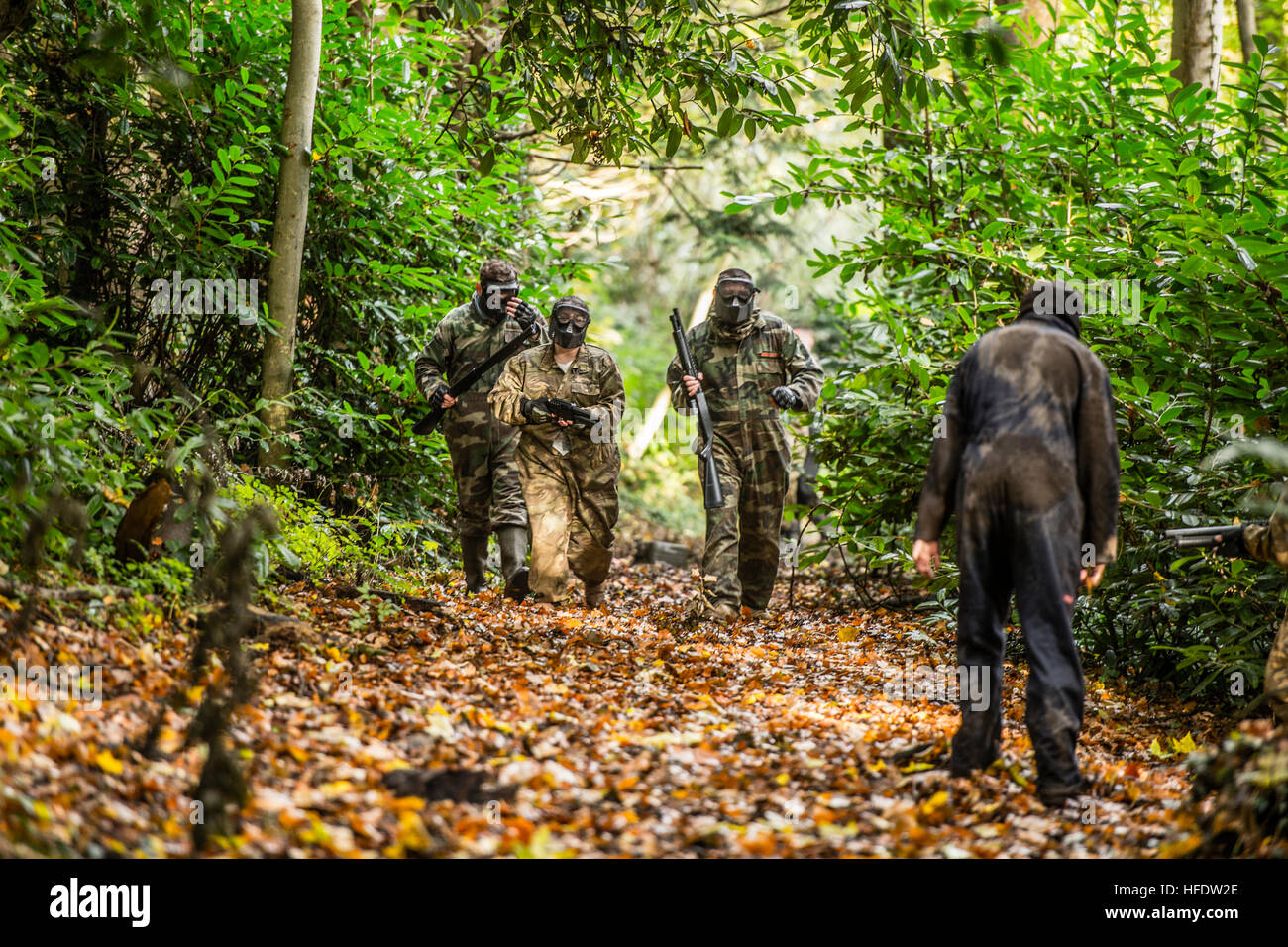 Groups of people dressed up in combat camouflage uniforms and carrying ...