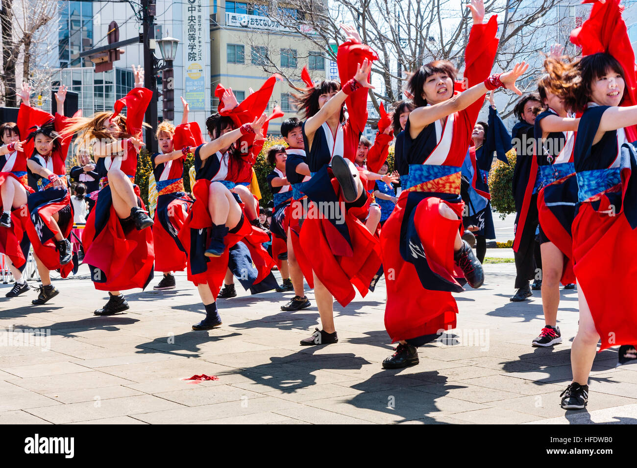 Japanese Yosakoi dance Festival. Young women dancers in red and blue  traditional yukata jackets, formation dancing in city square Stock Photo -  Alamy