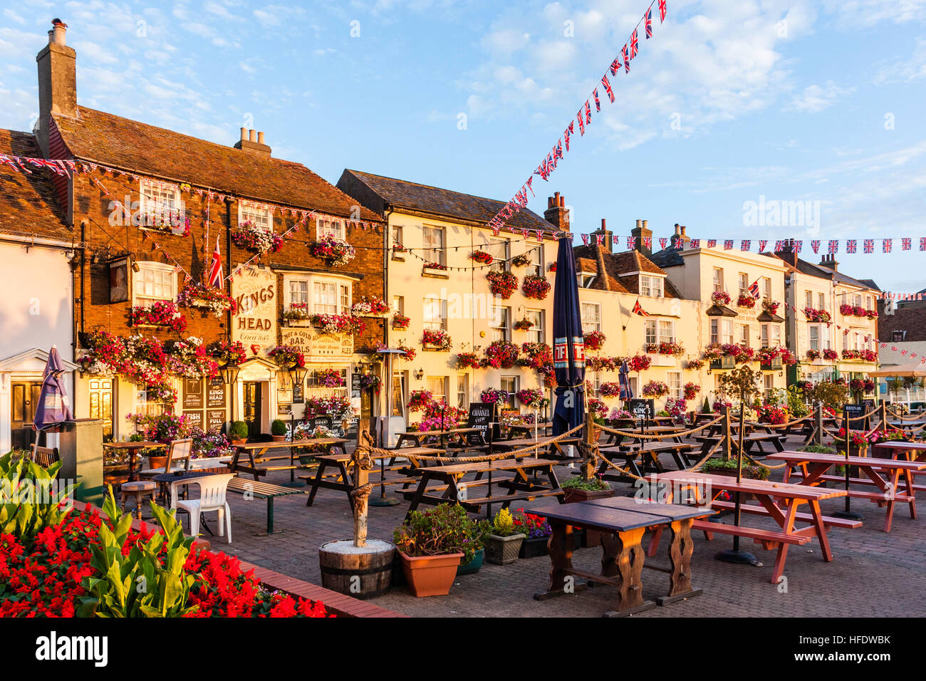 England, Deal. Terrace row of buildings. 17th century, 1643, Kings Head public House on Beach street, with Union Jack hanging. Sunlit, golden hour. Stock Photo