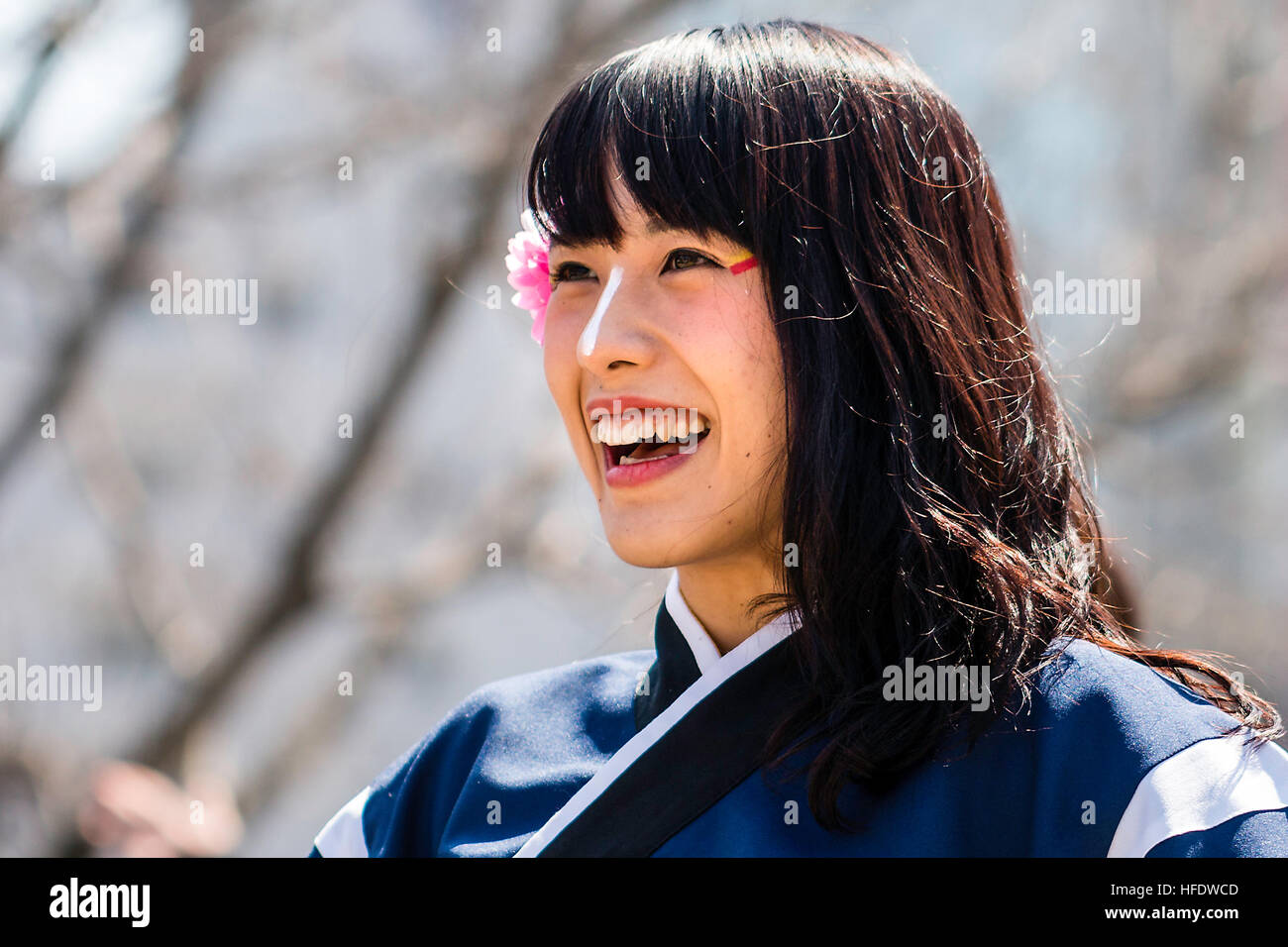Japan, Kumamoto. Hinokuni Yosakoi Festival. Woman dancer with flower in hair. Face, smiling with mouth open, happy. Close-up, head and shoulder. Stock Photo