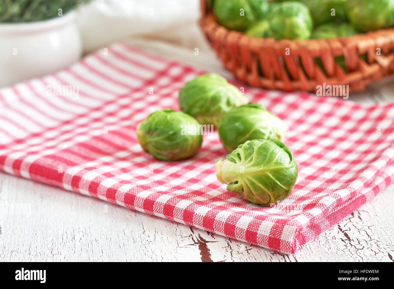 Fresh raw brussel sprouts on white rustic wooden background Stock Photo