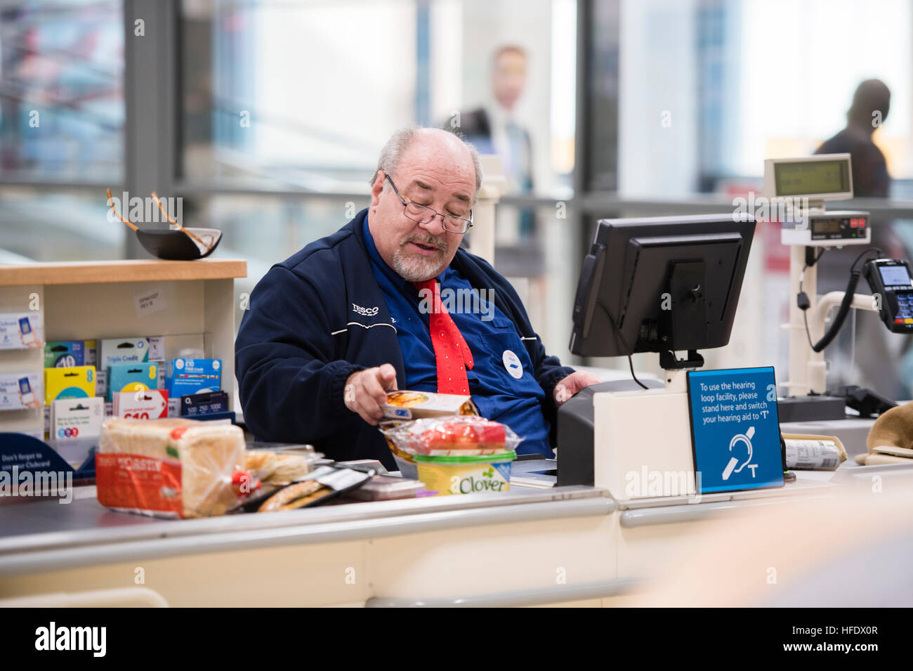 Supermarket checkout A man working on the checkout in the Tesco Stock
