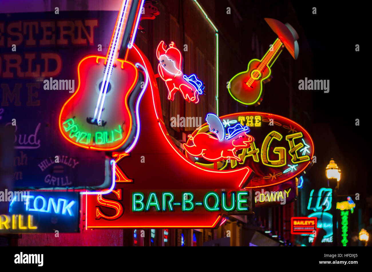 NASHVILLE - JULY 10, 2014: Bright neon signs of the city's honky tonk bar scene line the Broadway entertainment district. Stock Photo