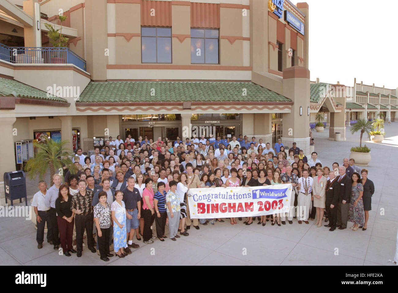 040723-N-3228G-002 Pearl Harbor, Hawaii (July 23, 2004) - Employees gather in front of the Pearl Harbor Navy Exchange (NEX) with Commander, Navy Region Hawaii/Commander, Naval Surface Group, Middle Pacific, Capt. Ronald R. Cox, for a group photo after receiving the 2003 Bingham Award. The Pearl Harbor NEX received the Bingham award for having more than $209 million in sales and excellence in customer service and employee satisfaction for 2003. The Bingham Award was named after the late Capt. W.H. Bingham, who in 1946 was directed by the Secretary of the Navy to establish the Navy Exchange syst Stock Photo