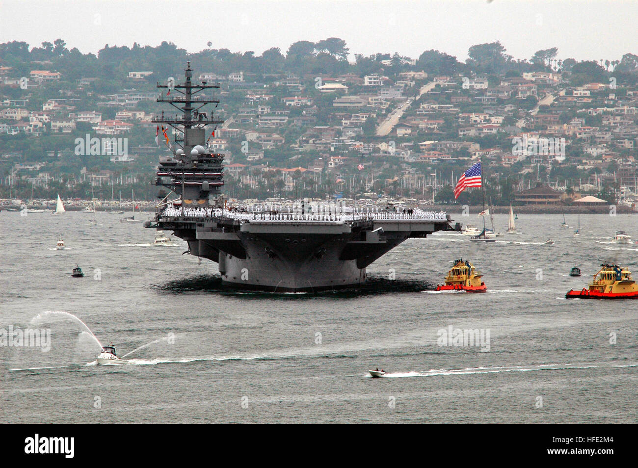 040723-N-7878F-094 San Diego, Calif. (July 23, 2004) - The NavyÕs newest and most technologically advanced aircraft carrier USS Ronald Reagan (CVN 76) enters San Diego harbor for a homeporting celebration, welcoming the ship to Naval Air Station North Island, and officially joining the U.S. Pacific Fleet. The celebration will included various dignitaries, including former First Lady Nancy Reagan, members of the Congress, state officials and celebrities. Commanded by Capt. James A. Symonds, the ship was commissioned in July 2003, and is completing a two-month transit around South America to her Stock Photo