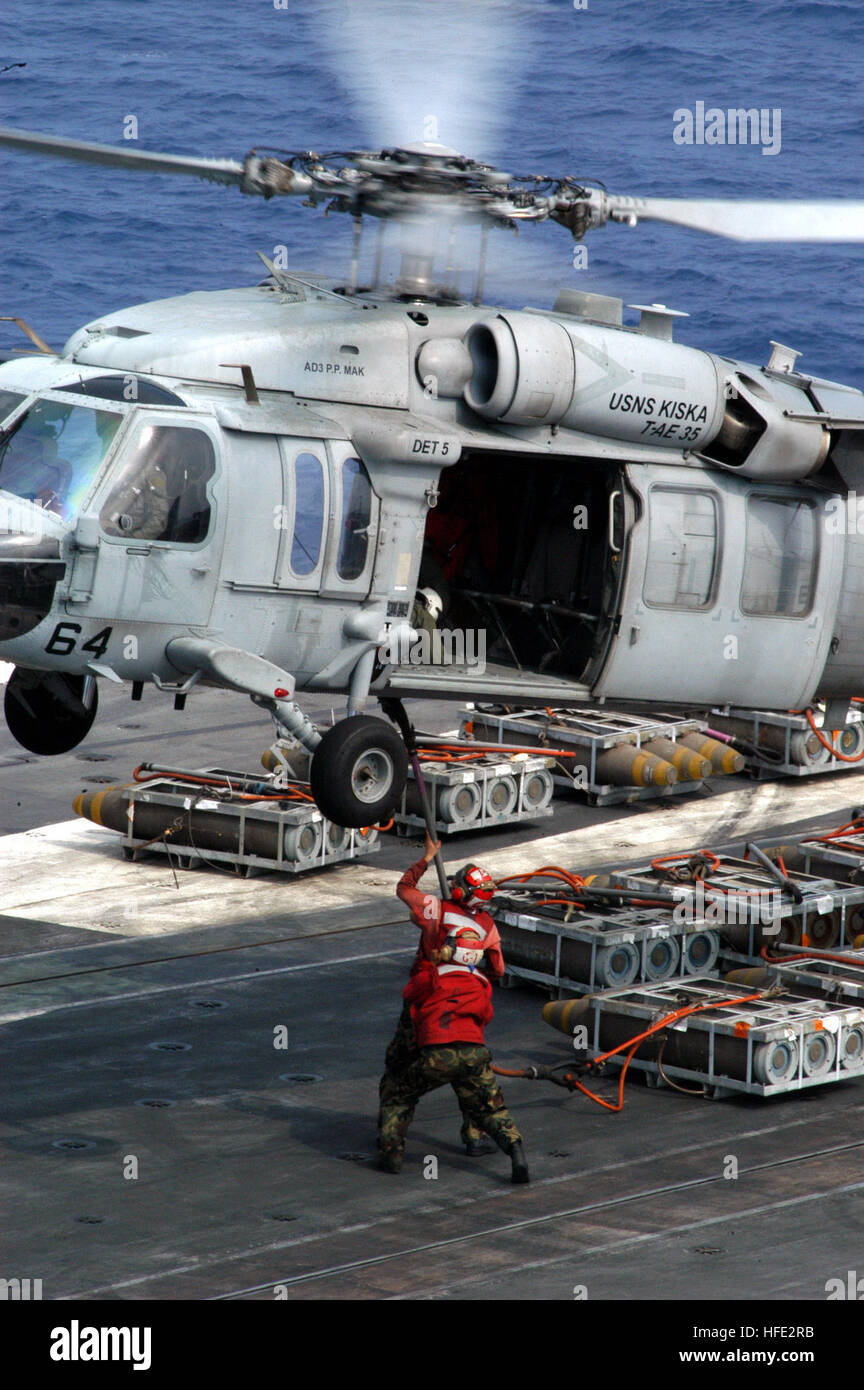 040724-N-5232L-001 Pacific Ocean (July 24, 2004) - Aviation ordnancemen hold a cargo pennant steady for connection to an HH-60H Seahawk during a Vertical Replenishment evolution between USS Kitty Hawk (CV 63) and military sealift command ammunition ship USNS Kiska (T-AE 35). Kitty Hawk is one of seven carrier strike groups (CSGs) involved in Summer Pulse 2004. Summer Pulse 2004 is the deployment of seven carrier strike groups (CSGs), demonstrating the ability of the Navy to provide credible combat capability across the globe, in five theaters with other U.S., allied, and coalition military for Stock Photo