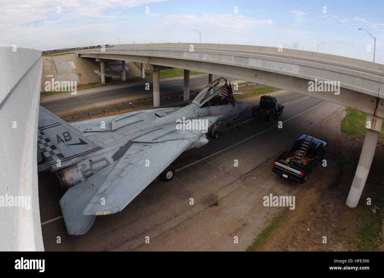 Only clearing the 16 foot clearance of an overpass by a few inches, an F-14A Tomcat finishes the last stretch of the 19.5 miles from San Angelo Regional Airport to Goodfellow Air Force Base Texas at a rate of 5 MPH after being decommissioned by the Navy.  This F-14A was the first F-14A to be decommissioned by the Navy and was bought by Goodfellow AFB for $20,000 to be used for training by the 312th Training Squadron's Fire Training Academy.  The plane's engines, weapons, and related systems had to be removed before transport to Goodfellow AFB and a few safety alterations will have to be made f Stock Photo
