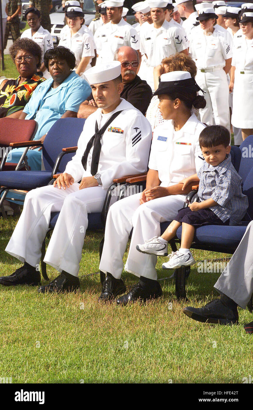 040811-N-0000N-005 Camp Lejeune, N.C. (Aug. 11, 2004) – Hospitalman Apprentice Luis E. Fonseca, Jr., sits with his family at a ceremony where the Secretary of the Navy, Gordon R. England presented him the Navy Cross for heroism during the battle of An Nasiriyah, Iraq, in March 2003. Under attack and without concern for his own safety, Hospitalman Apprentice Fonseca braved small arms, machine gun, and intense rocket-propelled grenade fire to evacuate wounded Marines from a burning amphibious assault vehicle. He stabilized two casualties with lower limb amputations with tourniquets and administe Stock Photo