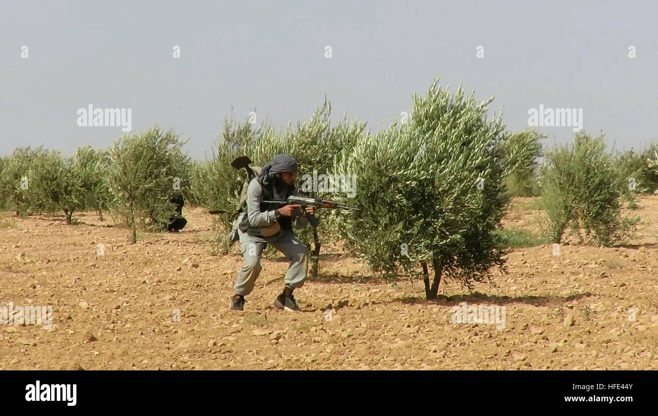 Still image taken from an ISIS propaganda video showing an Islamic State fighters advancing in an olive grove against Kurdish forces during a battle September 7, 2016 near Manbij, Aleppo province, Syria. Stock Photo