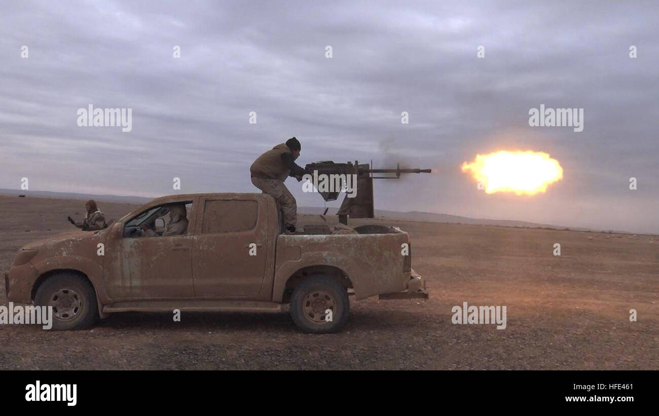 Still image taken from an ISIS propaganda video showing a technical vehicle outfitted with a heavy machine gun operated by Islamic State militants during battles against the Syrian Army December 10, 2016 in Homs province, Syria. Stock Photo