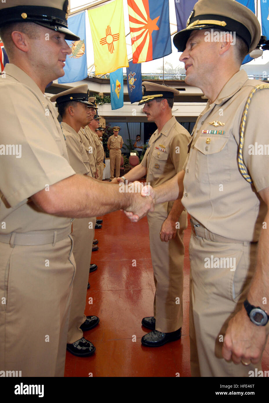 040916-N-3019M-001 Pearl Harbor, Hawaii (Sept. 16, 2004) - Commander, Navy Region Hawaii and Commander, Naval Surface Group, Middle Pacific, Capt. Michael C. Vitale and Commanding Officer, Naval Station Pearl Harbor, Capt. Ronald R. Cox, congratulate new chief petty officers (CPO) during their induction into the CPO community at a pinning ceremony held on board Pearl Harbor. The pinning ceremony is the culmination of six weeks of arduous physical training, practical team building and leadership exercises that will prepare them for their new duties and responsibilities as CPOÕs. U.S. Navy photo Stock Photo