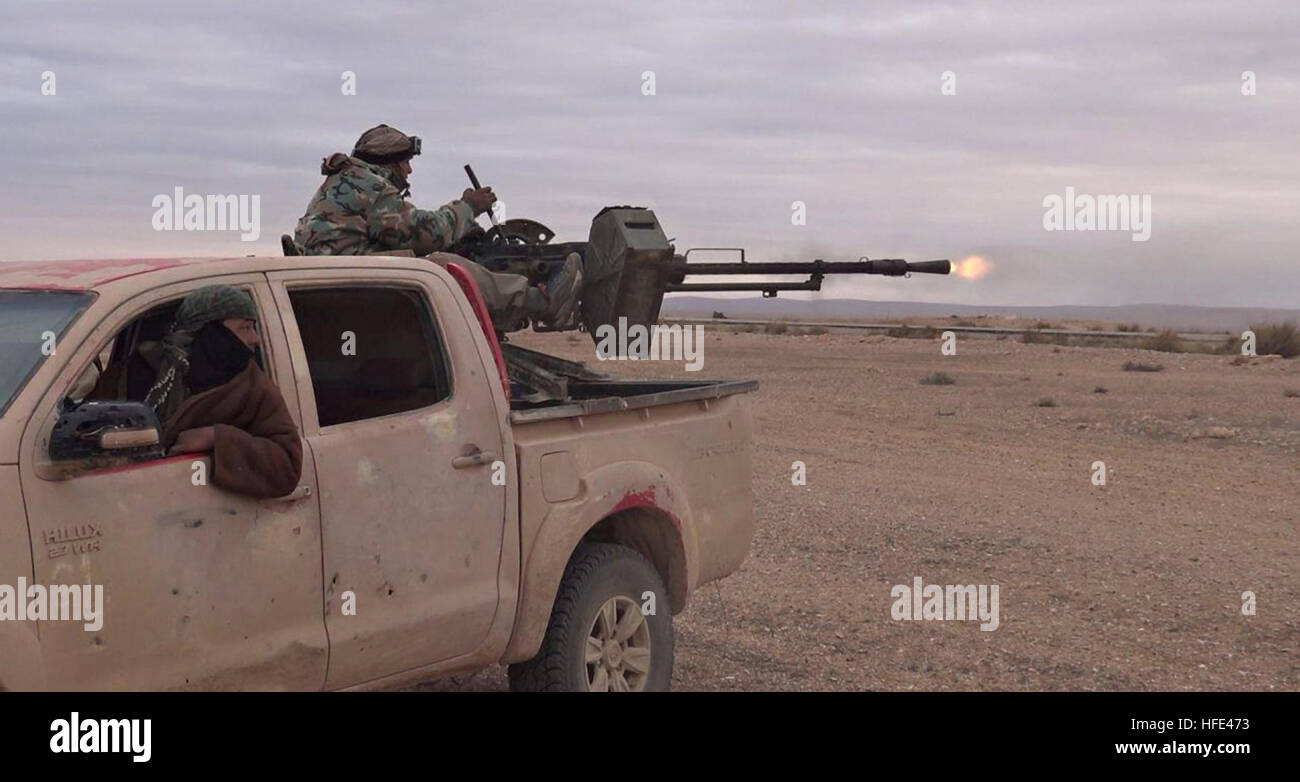 Still image taken from an ISIS propaganda video showing a technical vehicle outfitted with a heavy machine gun operated by Islamic State militants during battles against the Syrian Army December 9, 2016 in Homs province, Syria. Stock Photo