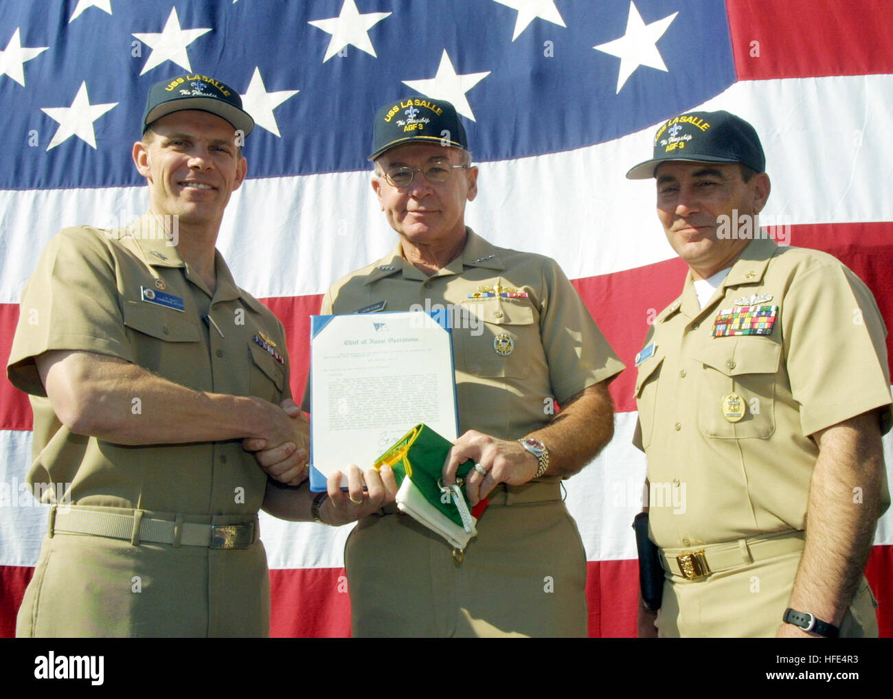 021014-N-6633C-004 Gaeta, Italy Oct. 14, 2002 -- Admiral Vern Clark, Chief of Naval Operations (center), presents Capt. John Haley (left), Commanding Officer of USS La Salle (AGF 3), land his Command Master Chief Dan Hatch, with the NavyÕs Meritorious Unit Commendation on behalf of the Secretary of the Navy.  The La Salle received the award for successfully completing a number of key inspections, as well as performing diplomatic and Maritime Interception Operations in the Mediterranean region.  U.S. Navy photo by Journalist 1st Class Gregory S. Cleghorne.  (RELEASED) US Navy 021014-N-6633C-004 Stock Photo