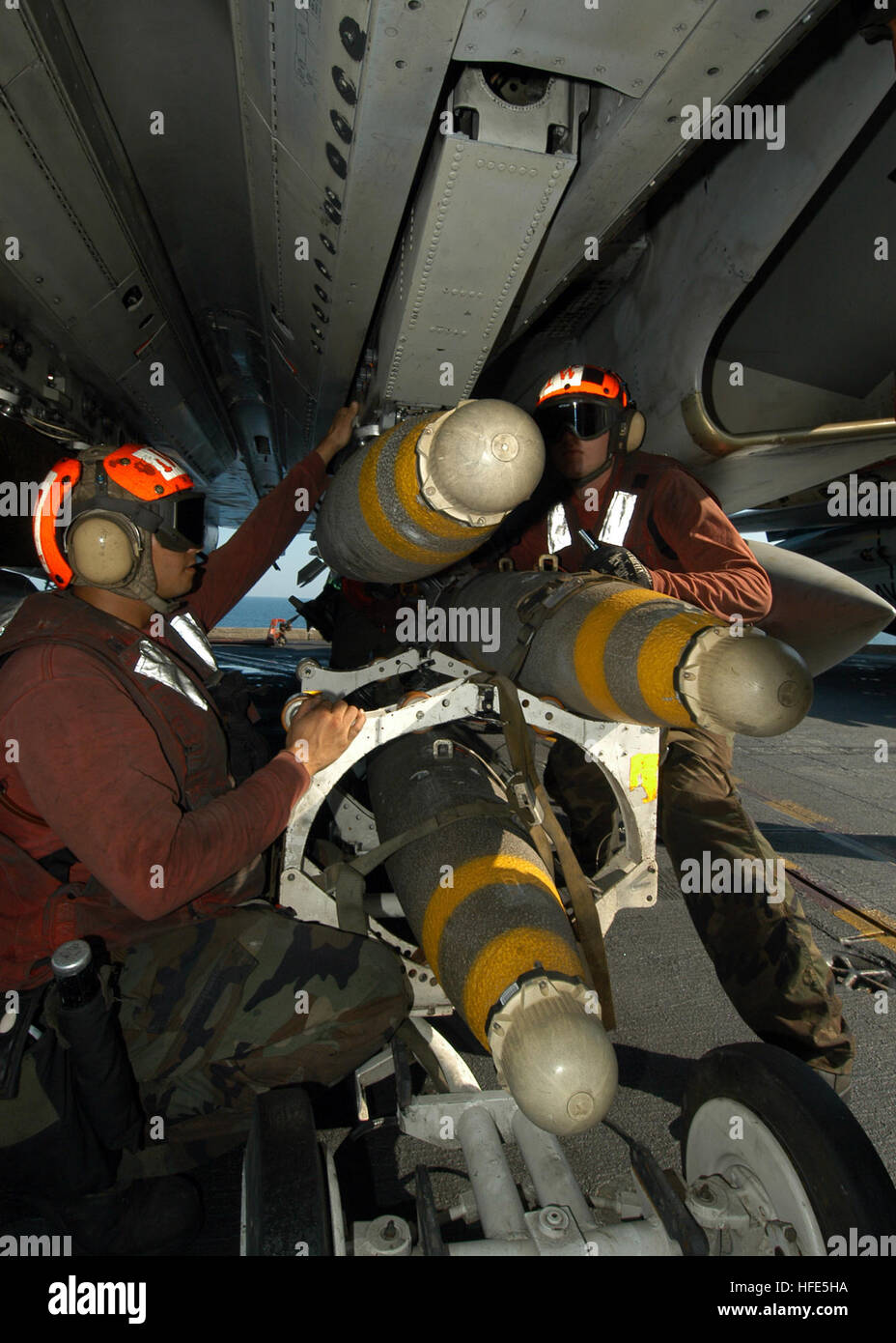 041108-N-8704K-006 Arabian Gulf (Nov. 8, 2004) - Aviation Ordnancemen, assigned to the ÒJolly RogersÓ of Fighter Squadron One Zero Three (VF-103), load Mk-83 1,000 pound general purpose bombs fitted with proximity-fuzes on an F-14B Tomcat aboard the aircraft carrier USS John F. Kennedy (CV 67). Carrier Air Wing Seventeen (CVW-17) aircraft aboard Kennedy are supporting ground troops in Fallujah, Iraq. Proximity-fuzed bombs are used against targets such as troops in trenches, radars, trucks, and other vehicles. Kennedy and embarked CVW-17 are currently on deployment in the 5th Fleet area of resp Stock Photo