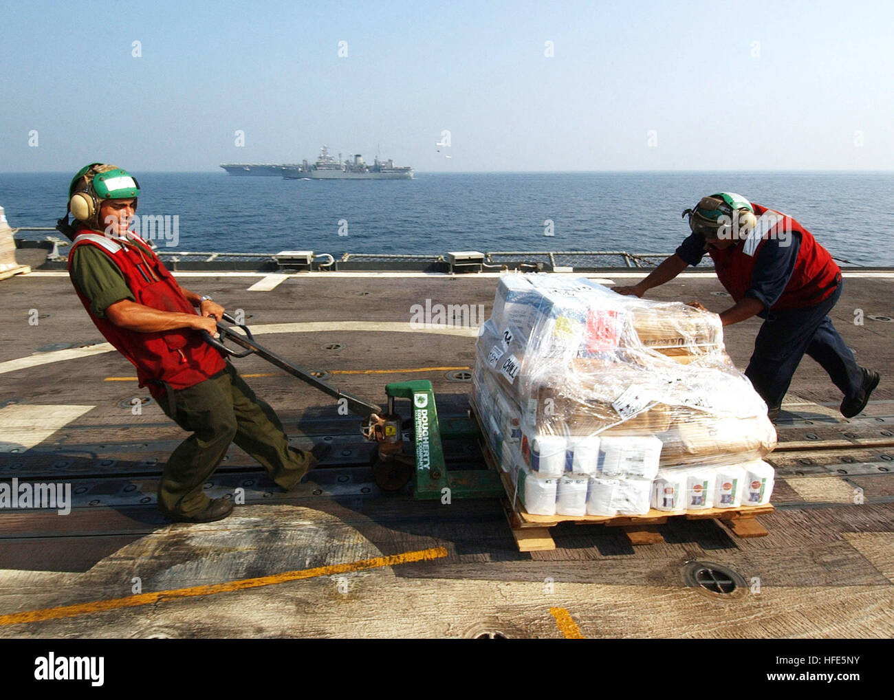 041112-N-4374S-007 Arabian Gulf (Nov. 12, 2004) - Sailors assigned to the ÒProud WarriorsÓ of Helicopter Anti-Submarine Squadron Light Four Two (HSL-42), move a pallet of stores across the flight deck of the guided missile cruiser USS Vicksburg (CG 69), during a vertical replenishment (VERTREP) with the Military Sealift Command (MSC) combat stores ship USNS Saturn (T-AFS 10).  Vicksburg is part of USS John F. Kennedy (CV 67) Carrier Strike Group currently on a regularly scheduled deployment in support of Operation Iraqi Freedom (OIF). U.S. Navy photo by PhotographerÕs Mate 2nd Class Michael Sa Stock Photo