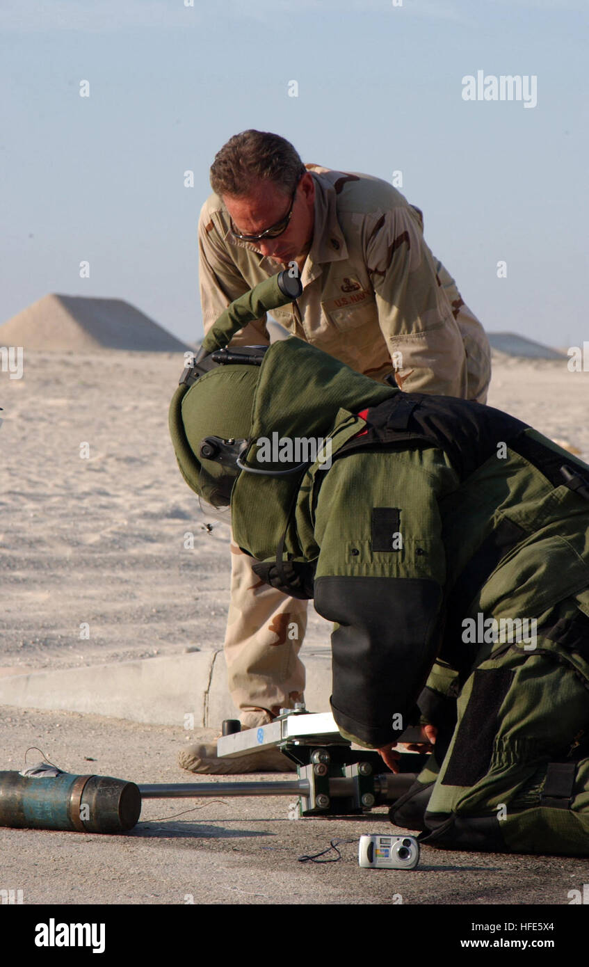 041110-N-7469S-002 5th Fleet Area of Responsibility (Nov. 10, 2004) - A Sailor assigned to Explosive Ordnance Disposal Mobile Unit Four (EODMU-4), Detachment Ten, assists another Sailor in rendering an Improvised Explosive Device (IED) safe for disposal. EODMU-4, Det. 10, conducted a Final Evaluation Phase of training to simulate operations the team may experience their area of operation. U.S. Navy photo by Journalist 2nd Class Elton Shaw (RELEASED) US Navy 041110-N-7469S-002 A Sailor assigned to Explosive Ordnance Disposal Mobile Unit Four (EODMU-4), Detachment Ten, assists another Sailor in  Stock Photo