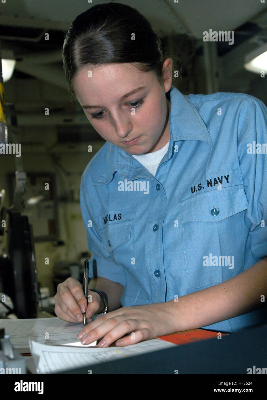 041117-N-5313A-004 Atlantic Ocean (Nov. 16, 2004) - Lithographer Seaman Christen R. Nicholas double checks her work on a Planned Maintenance System job sheet, in the print lab aboard the amphibious assault ship USS Kearsarge (LHD 3). The Kearsarge Expeditionary Strike Group and the 26th Marine Expeditionary Unit (MEU) are conducting initial integrated training in preparation for an upcoming scheduled deployment.  U.S. Navy photo by Photographer's Mate Airman Sarah E. Ard (RELEASED) US Navy 041117-N-5313A-004 Lithographer Seaman Christen R. Nicholas double checks her work on a Planned Maintenan Stock Photo
