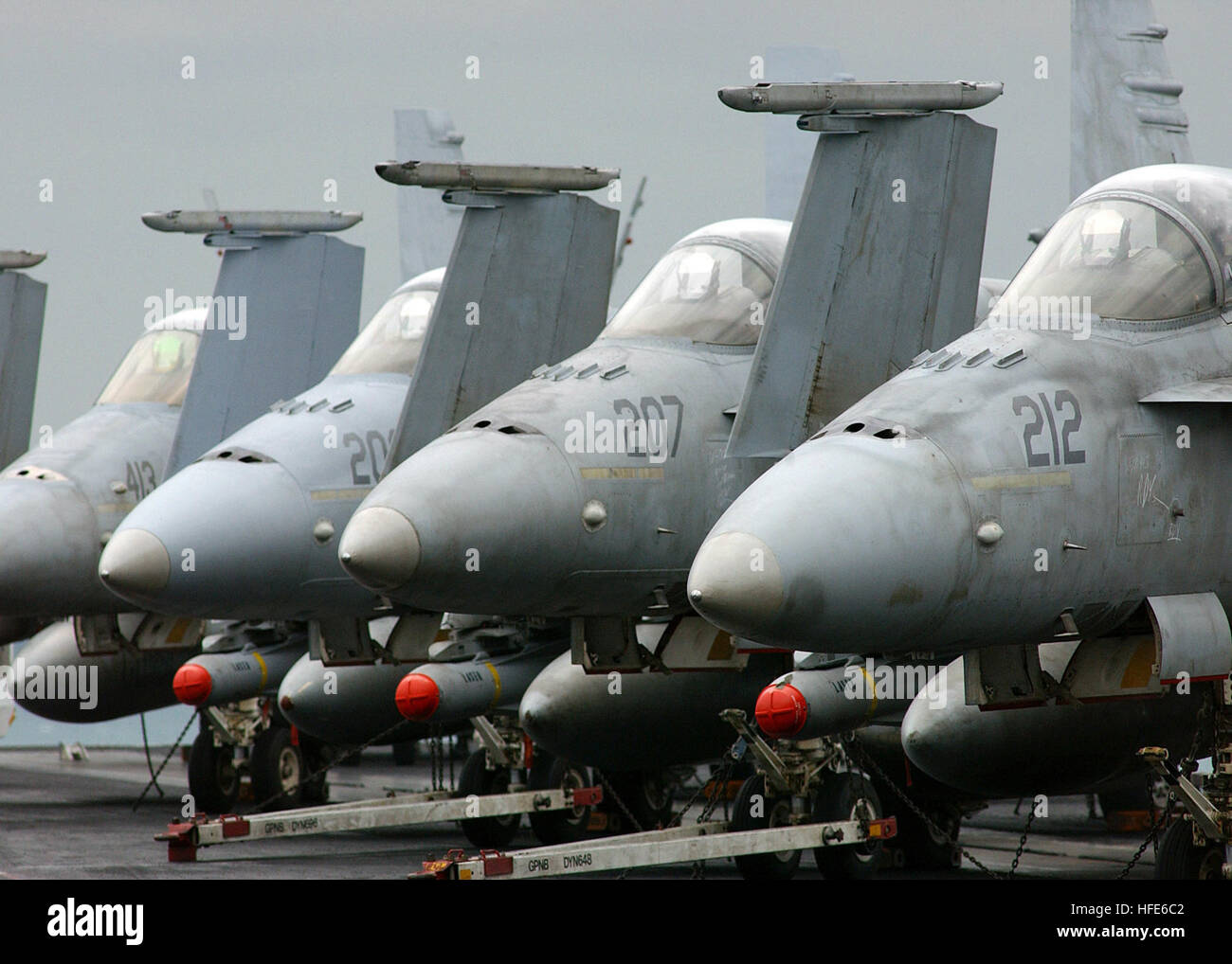 041201-N-5345W-131 (Arabian Gulf) F/A-18 Hornets sit idle in formation on the flight deck of the Nimitz-class aircraft carrier USS Harry S. Truman (CVN-75).  Truman's Carrier Strike Group Ten (CSG-10) and her embarked Carrier Air Wing Three (CVW-3) are currently on a regularly scheduled deployment in support of the Global War on Terrorism.  US Navy photo by Photographer's Mate Airman Kristopher Wilson.  (Released by HST Public Affairs) US Navy 041201-N-5345W-131 F-A-18A Hornets, assigned to the Silver Eagles of Marine Fighter Attack Squadron One One Five (VMFA-115), armed with AGM-65 Maverick  Stock Photo