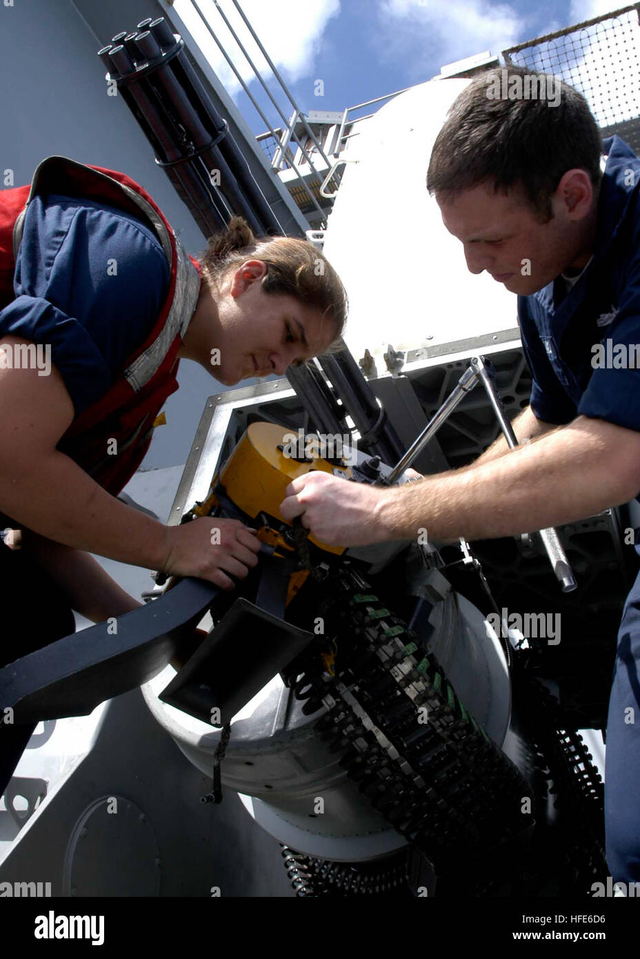 041202-N-5837R-231 Pacific Ocean (Dec. 2, 2004) - Fire Controlman 3rd Class Rose Gregory, left, and Fire Controlman 2nd Class Christian Blanco attach the loader assembly to a Close-In Weapons System (CIWS) prior to loading ÒdummyÓ rounds after a live-fire drill aboard the Nimitz-class aircraft carrier USS Abraham Lincoln (CVN 72). Lincoln and embarked Carrier Air Wing Two (CVW-2) are currently deployed to the Western Pacific Ocean. U.S. Navy photo by Photographer's Mate Airman Apprentice Timothy C. Roache Jr. (RELEASED) US Navy 041202-N-5837R-231 Fire Controlman 3rd Class Rose Gregory, left, a Stock Photo